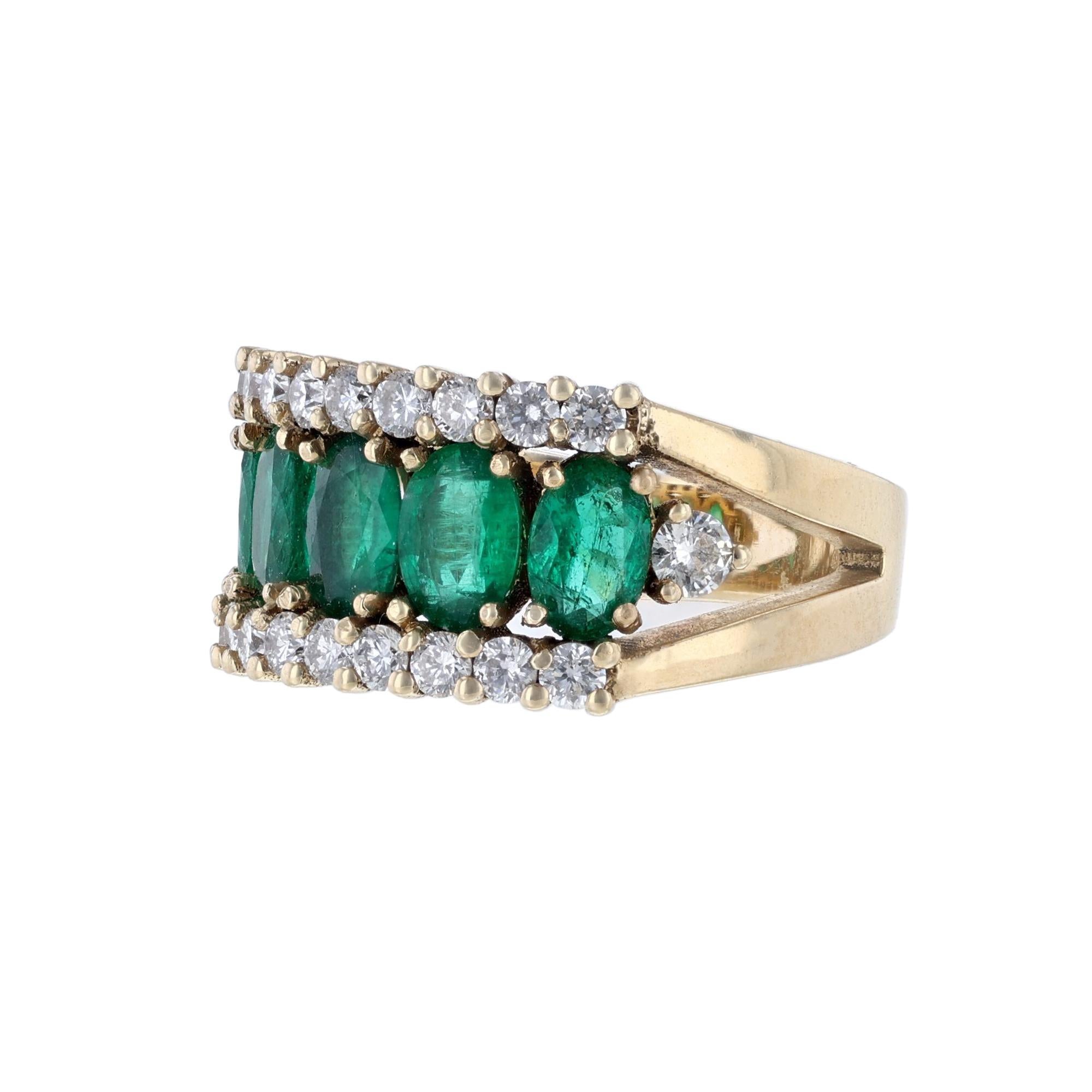 This ring is made in 14K yellow gold. It features 5 oval cut emeralds weighing 1.86 carats. Also features 20 round cut diamonds weighing 0.81 carat. The stones are all set with prongs. With a color grade (H) and clarity grade (SI2).

