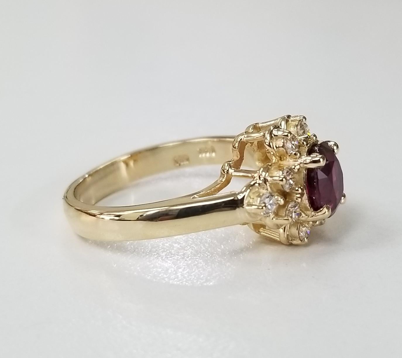 14 karat yellow gold oval Ruby diamond ring, containing 1  GIA oval ruby of gem quality weighing 1.20cts.,surrounded with 10 round full cut diamonds of fine quality weighing .35pts.  This ring is a size 6.75 but we will size to fit for free.