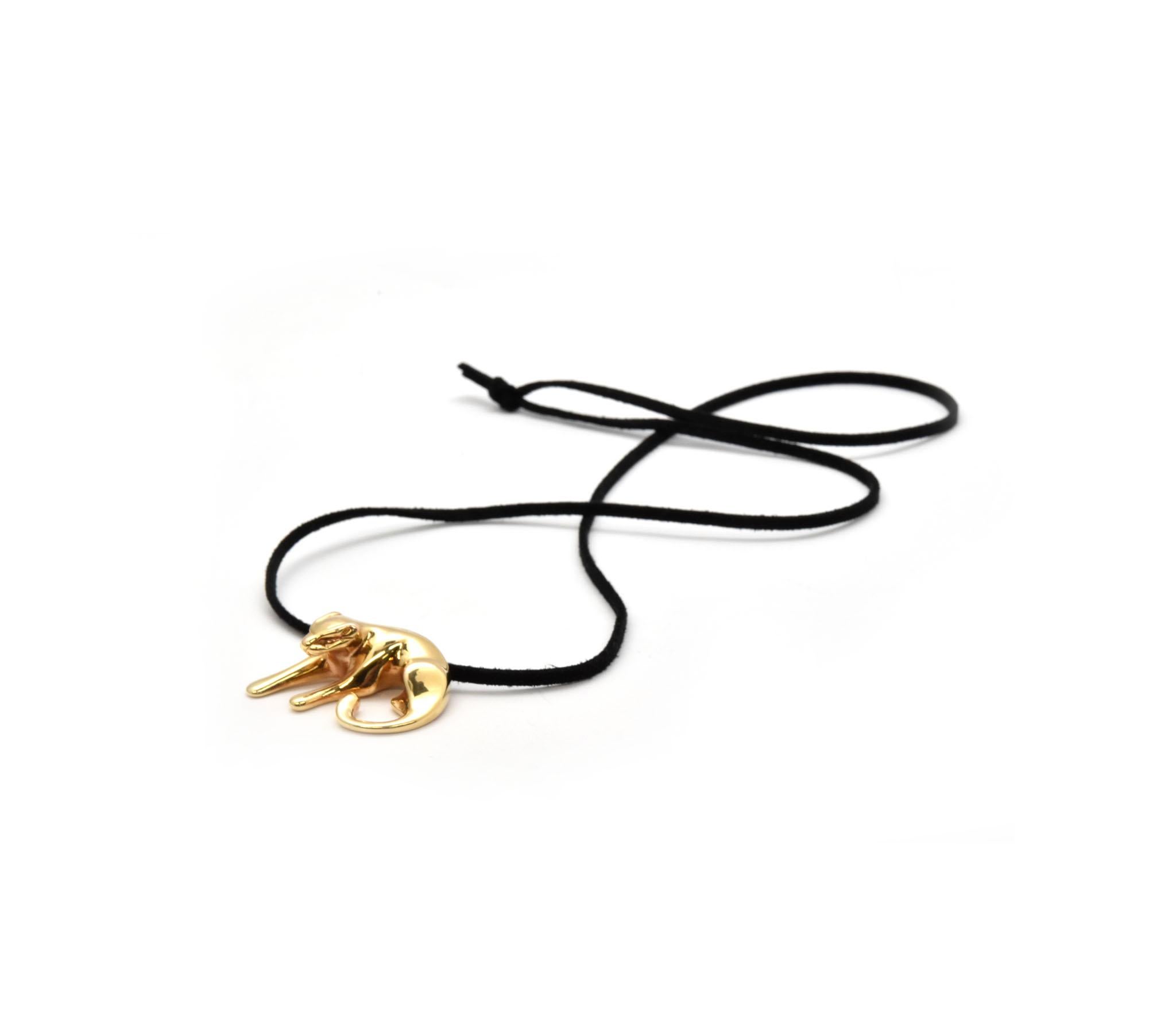 This fabulous pendant features a sleek depiction of a panther crafted in 14k yellow gold. The black silk cord is 15 inches long. The panther pendant slides along a smooth black silk cord. The gold panther is stamped “14k Italy”. This pendant has