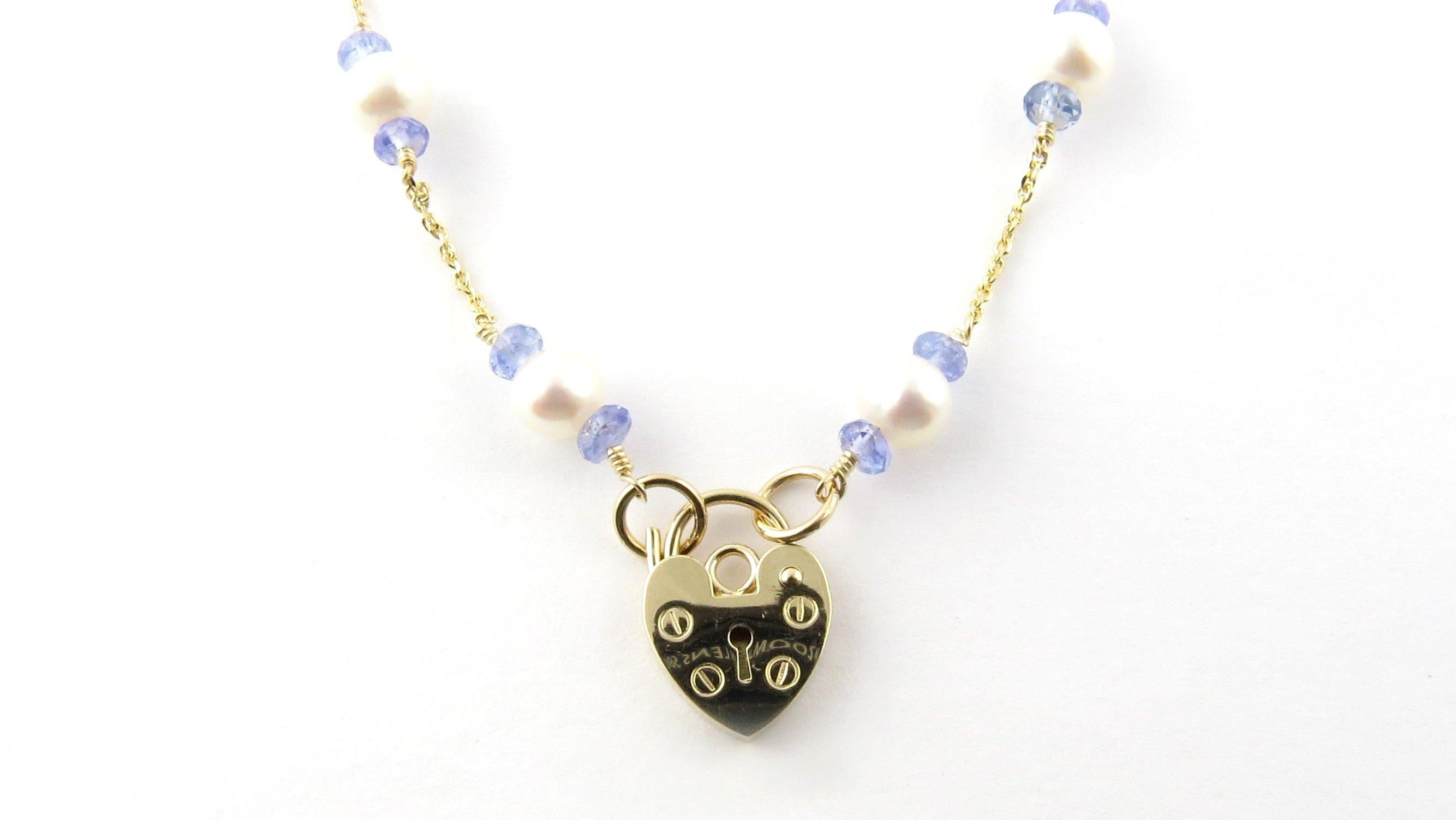 Vintage 14 Karat Yellow Gold Pearl and Blue Bead Necklace- 
This delicate 14K yellow gold necklace features 16 cultured pearls (5 mm each) accented with 32 blue beads and a lovely heart closure. 
Size: 16 inches 
Weight: 4.5 dwt. / 7.1 gr.