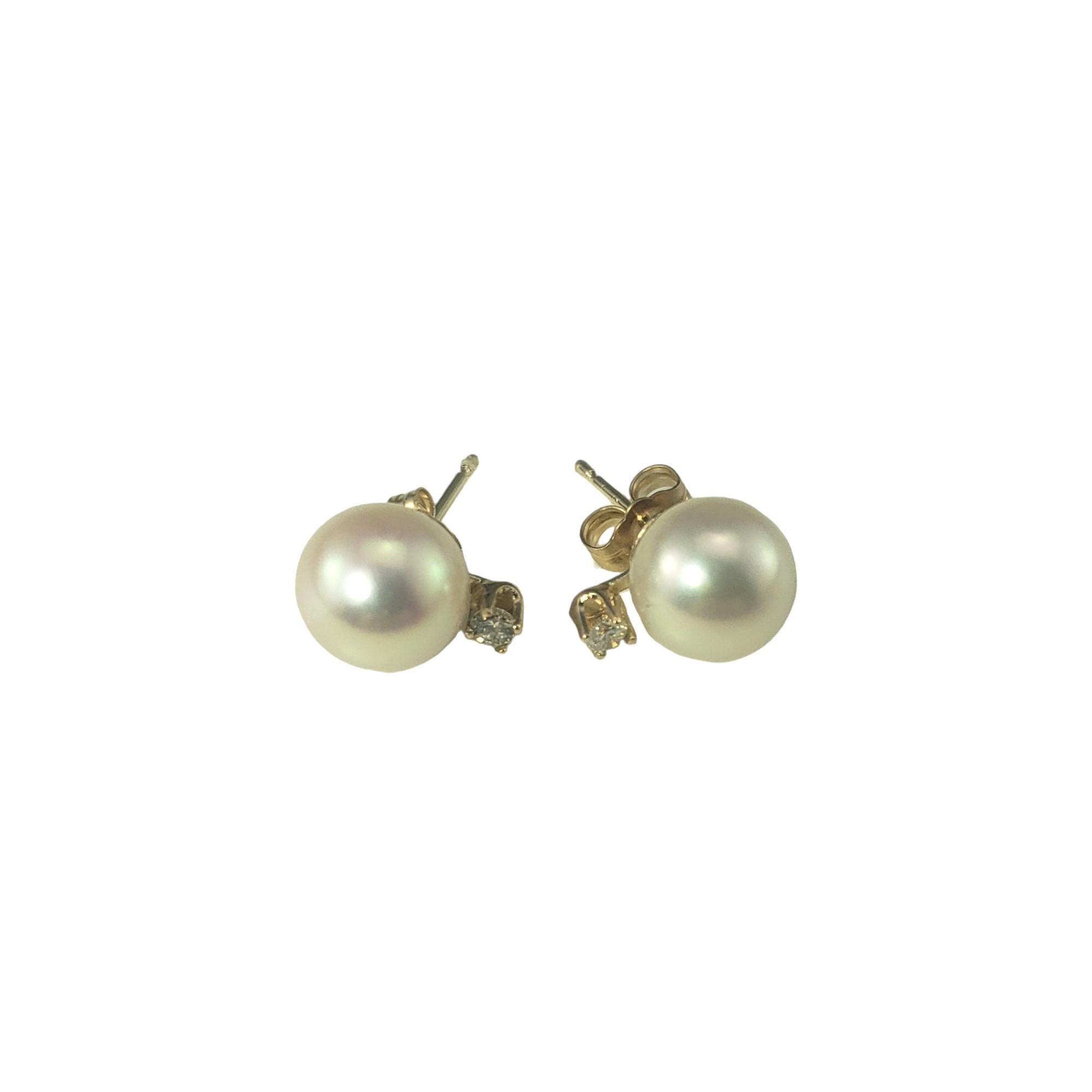 Vintage 14 Karat Yellow Gold Pearl and Diamond Earrings-

These elegant earrings each feature one round pearl (8 mm) and one round brilliant cut diamond set in classic 14K yellow gold.  Push back closures.

Approximate total diamond weight: .08