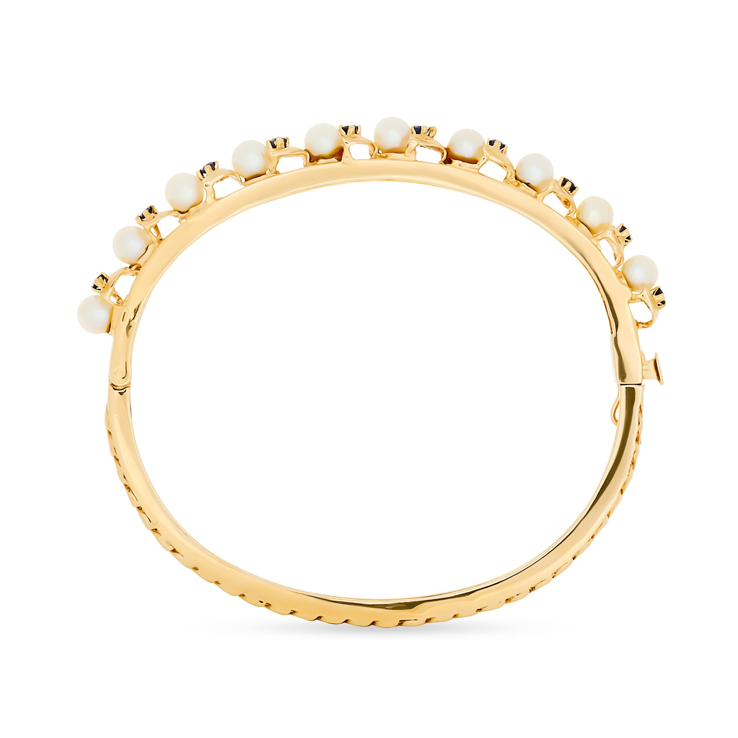 Ce bracelet délicat présente une alternance de perles rondes d'un blanc crémeux et de petits saphirs bleus vibrants, sertis en canal dans une fine bande d'or jaune poli, créant ainsi une pièce classique mais subtilement colorée.

Comprend 10 saphirs