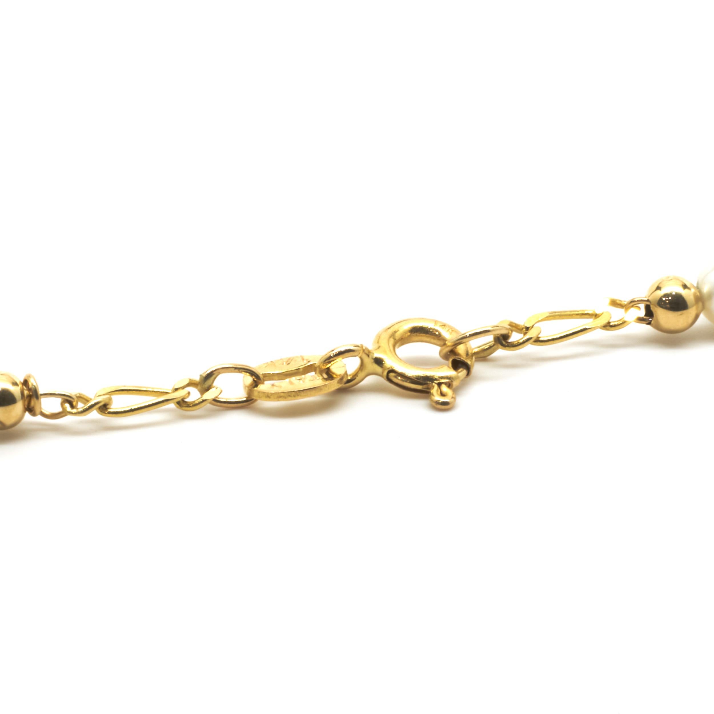 Designer: Custom
Material: 14K yellow gold
Dimensions: necklace measures 18-inches in length, 2.5-inch pearl drop
Weight: 7.48 grams
