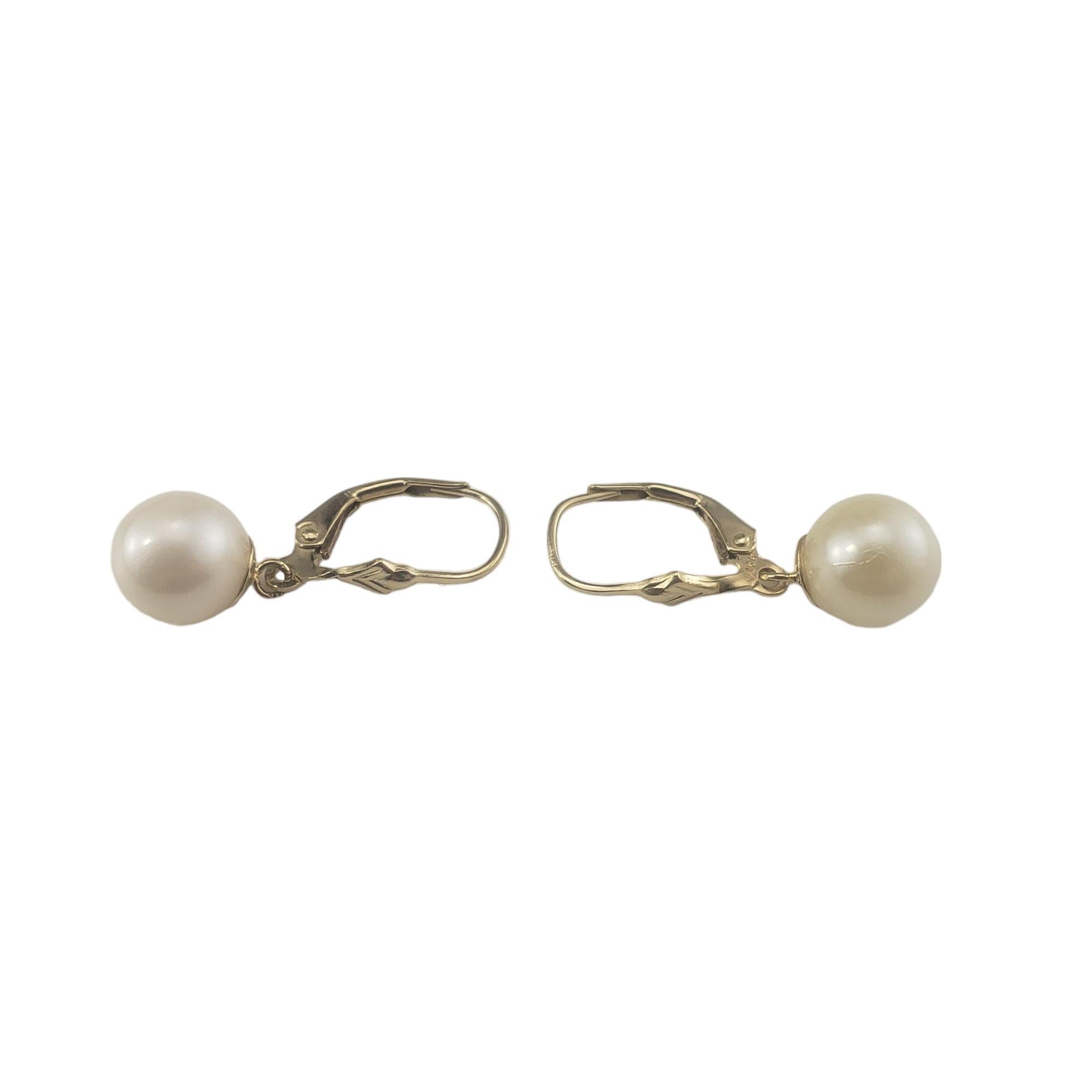 Vintage 14 Karat Yellow Gold Pearl Dangle Earrings-

These elegant earrings each feature one white pearl (9 mm) set in classic 14K yellow gold.  Hinged closures.

Size: 27 mm x 9 mm

Stamped: 14K CL

Weight: 1.7 dwt./ 2.7 gr.

Very good condition,