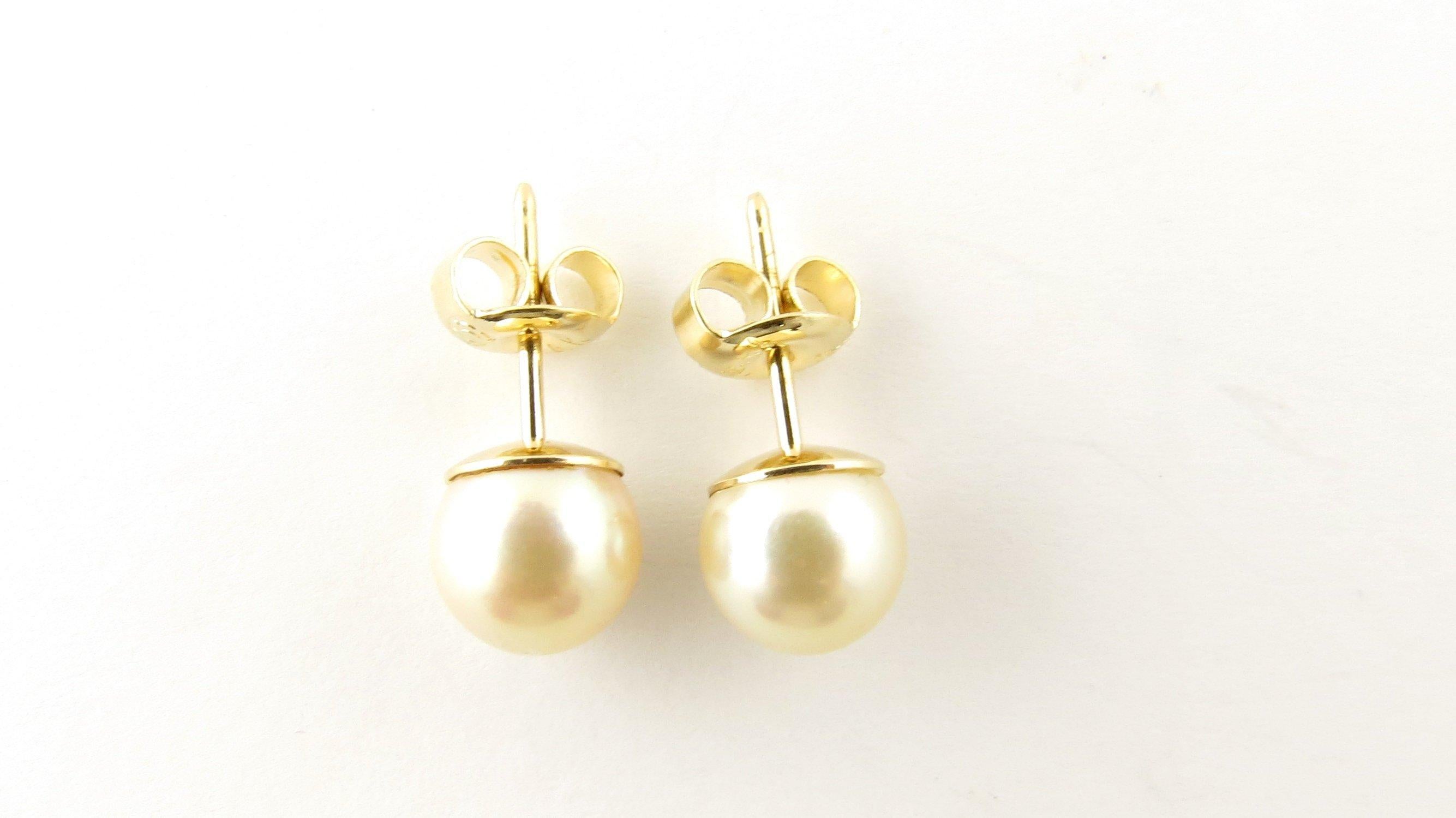 Vintage 14 Karat Yellow Gold Pearl Earrings- These elegant stud earrings each feature one 7 mm cultured pearl set in classic 14K yellow gold. Push back closures. Size: 7 mm Weight: 0.5 dwt. / 0.8 gr. Stamped: 14K Italy Very good condition,
