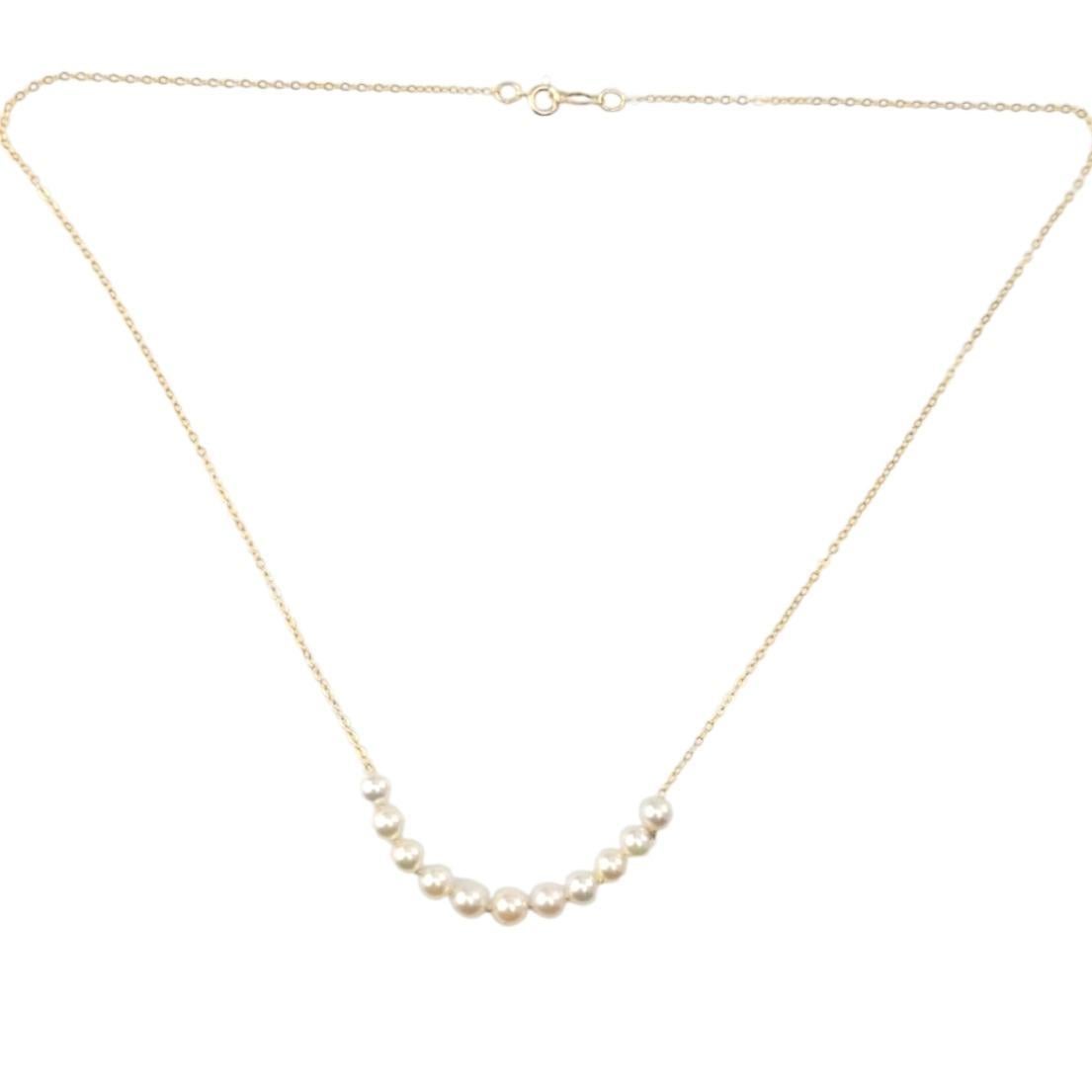 Collana di perle in oro giallo 14K

Questa collana di perle in oro giallo 14 carati presenta 11 perle lucenti e perfettamente abbinate, infilate in una catena delicata che crea un pezzo elegante e senza tempo. Ideale per le occasioni formali o come