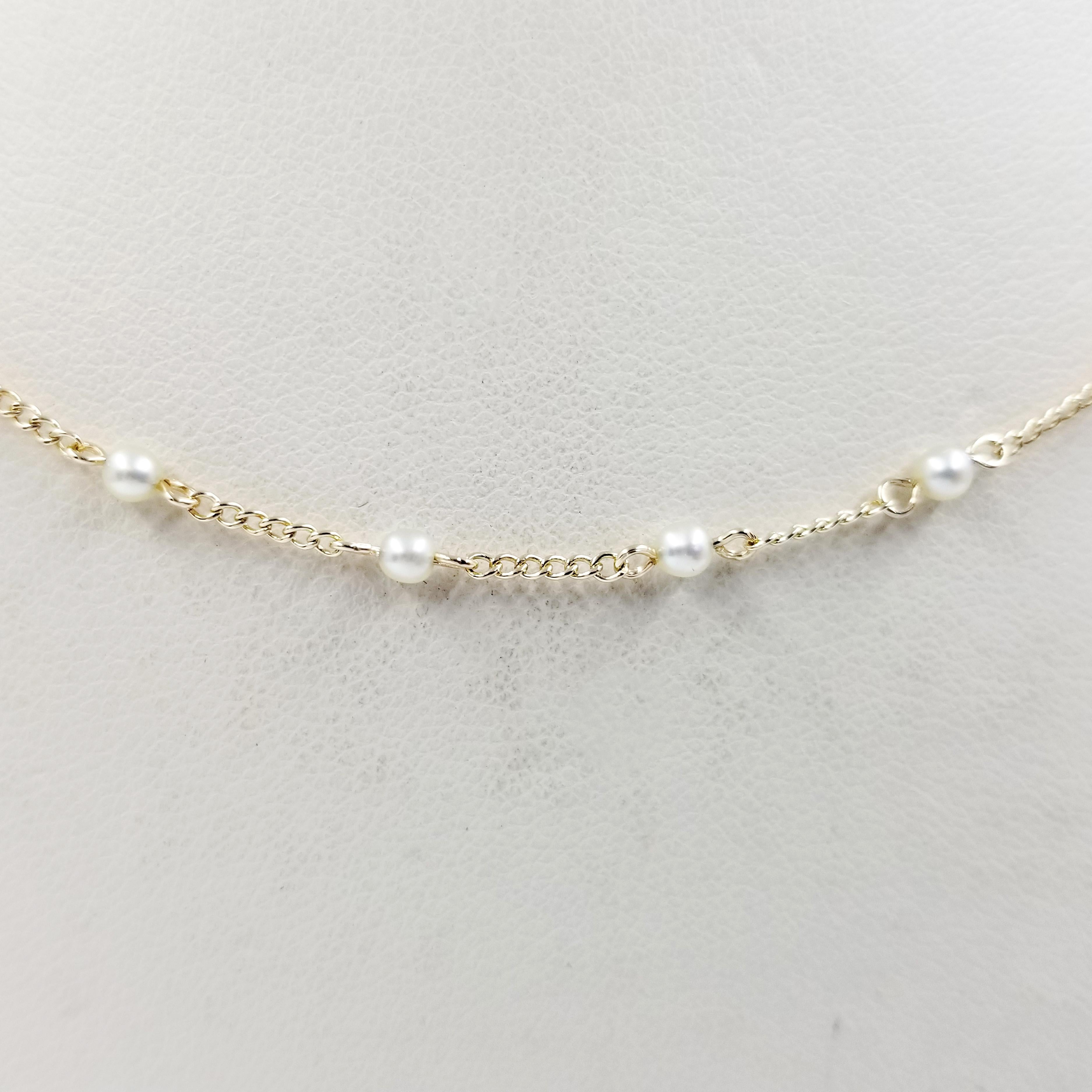 14 Karat Yellow Gold Necklace with Small Cultured Round Pearls. Length is 15 Inches; this is a perfect length for a choker or child's necklace. Finished Weight is 2.3 Grams.