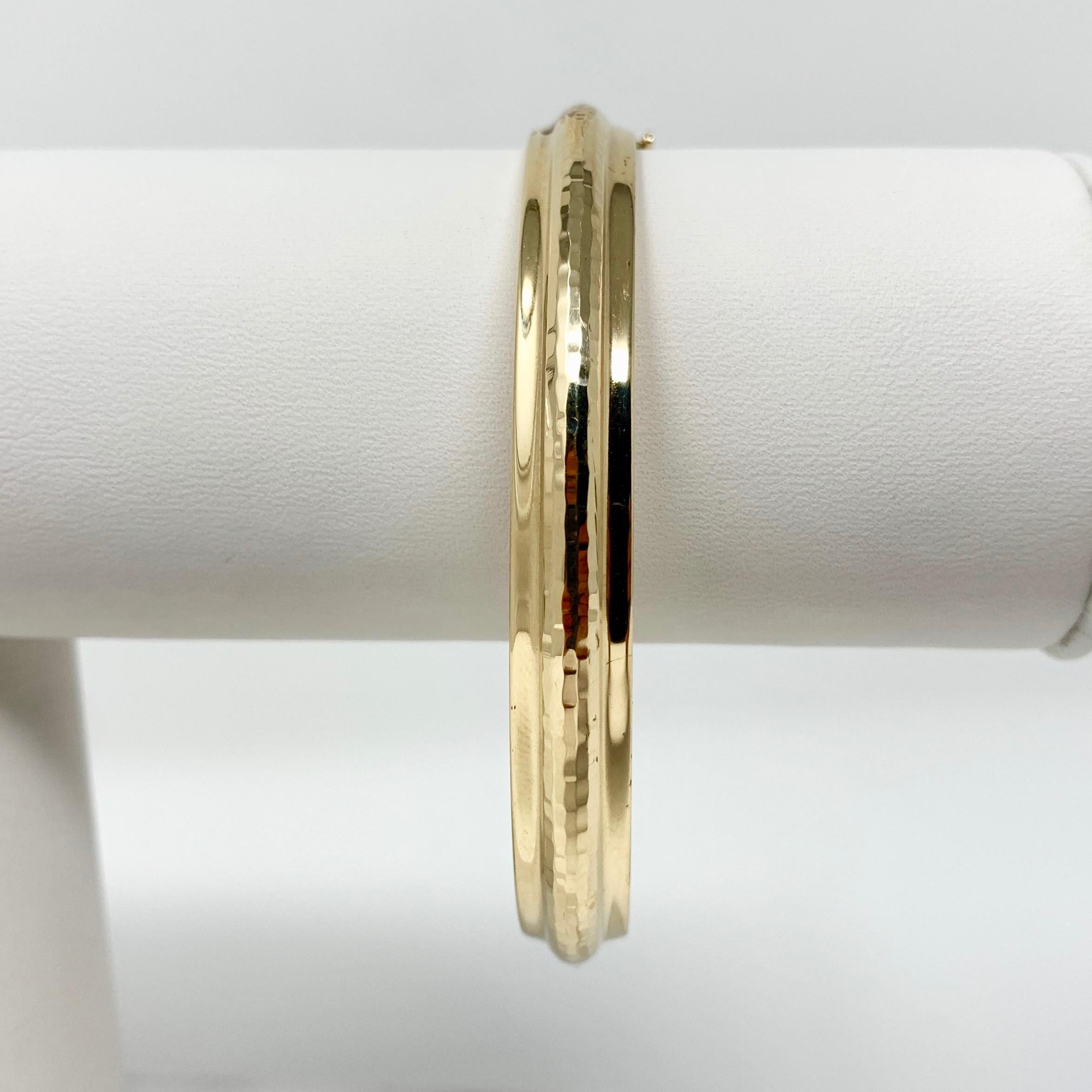 14k Yellow Gold Polished Hammered Texture Bangle Bracelet 7.5 Inches

Condition:  Excellent Condition, Professionally Cleaned and Polished
Metal:  14k Gold (Marked, and Professionally Tested)
Weight:  8.8g
Length:  7.5 Inches 
Width:  8mm 
Closure: 