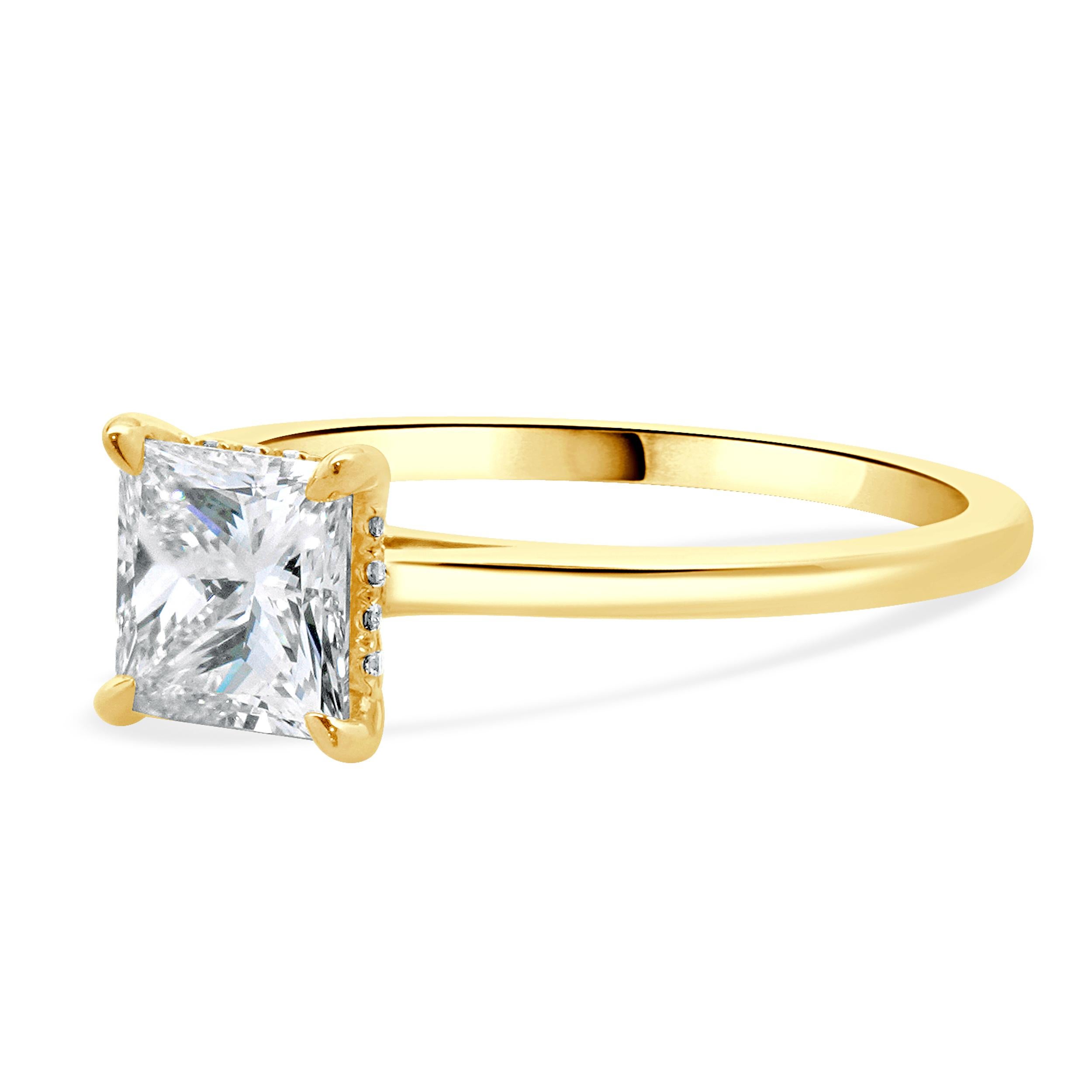 Designer: custom
Material: 14K yellow gold
Diamond: 1 princess cut = 1.10ct
Color: G
Clarity: VS1
GIA: 2151204687
Diamond: 16 round brilliant cut = 0.06cttw
Color: G
Clarity: VS1-2
Dimensions: ring top measures 6mm wide
Ring Size: 6.5 (complimentary