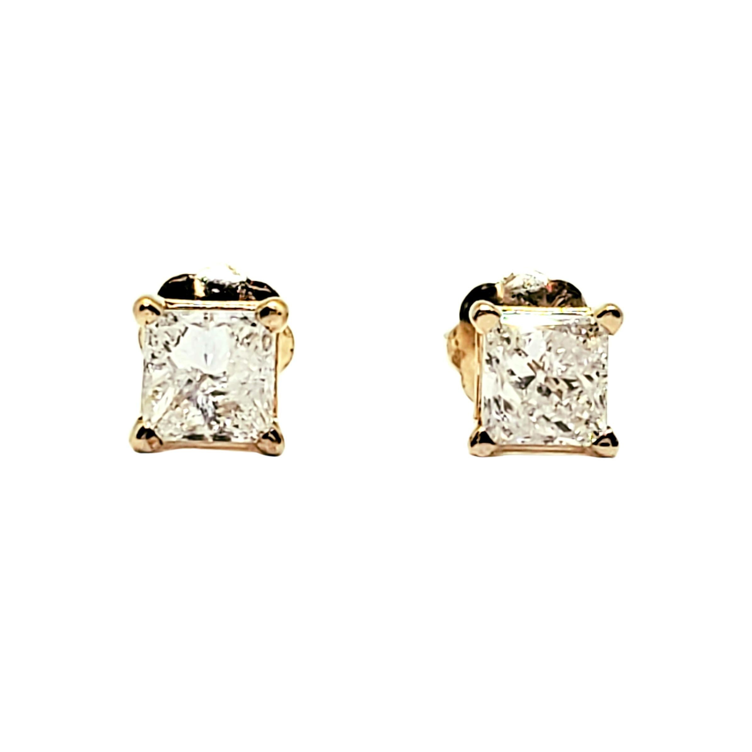 Vintage 14 Karat Yellow Gold Princess Cut Diamond Earrings (.50 ct. )

These sparkling earrings each feature one princess cut diamond set in classic 14K yellow gold. Screw back closures.

Approximate total diamond weight: .50 ct.

Diamond color: