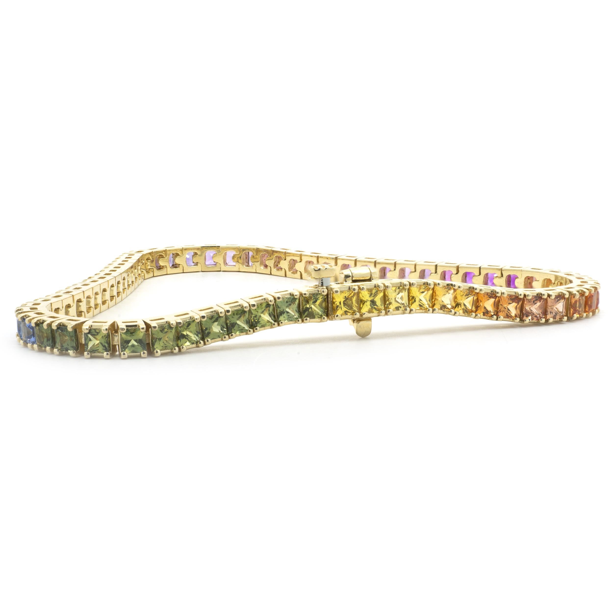 Designer: custom
Material: 14K yellow gold
Sapphire: 56 princess cut = 10.56cttw
Color: Rainbow
Clarity: AAA
Dimensions: bracelet will fit up to a 7-inch wrist
Weight: 14.03 grams
