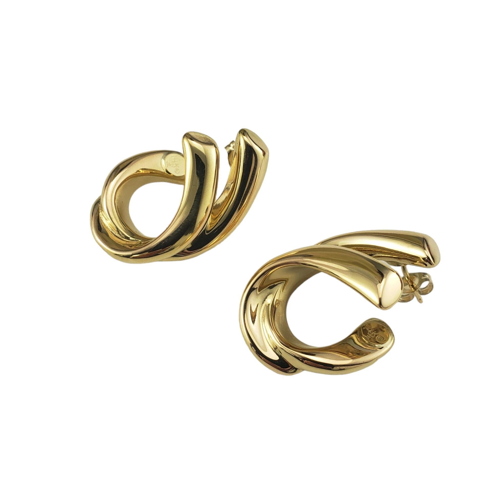 Vintage 14 Karat Yellow Gold Ribbon Hoop Earrings-

These elegant earrings are crafted in meticulously detailed 14K yellow gold.  Push back closures.

Size: 29 mm x 10 mm

Stamped: 14K

Weight: 2.1 dwt./ 3.2 gr.

Very good condition, professionally