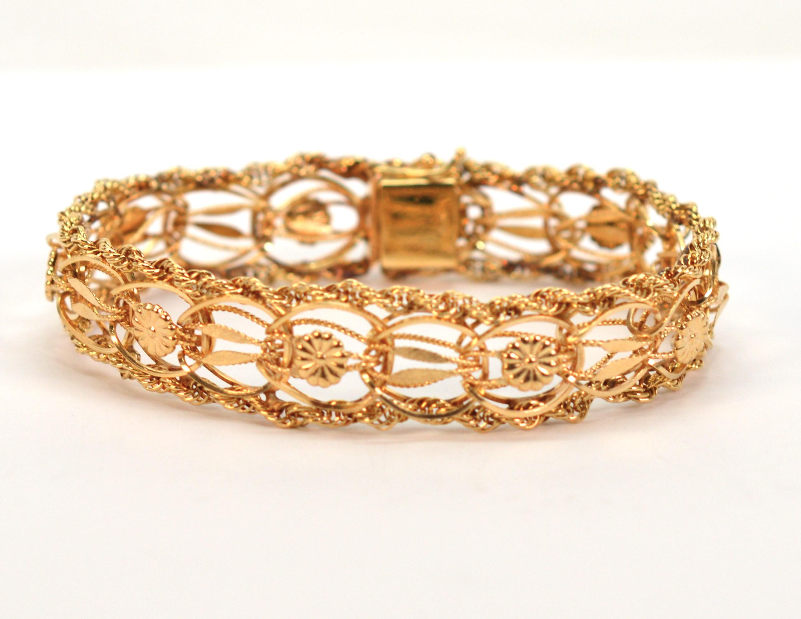 Mid-century bliss in 14 karat yellow gold, this 7 inch long bracelet displays the attractive attributes of this popular 1950 / 1960 retro style charm bracelet within a modern 1/2 inch width. Certainly relevant today, this always flattering style