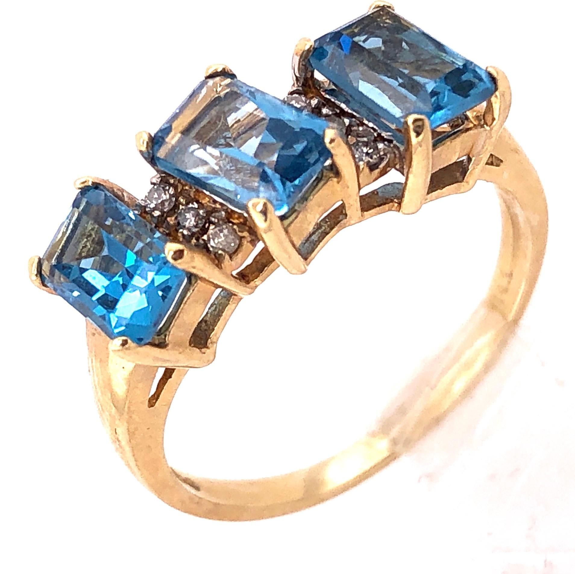 14 Karat Yellow Gold Ring Princess Cut Three Blue Topaz With Diamond Accents
0.06 Total Diamond Weight
Size 6.5
2.97 grams total weight.