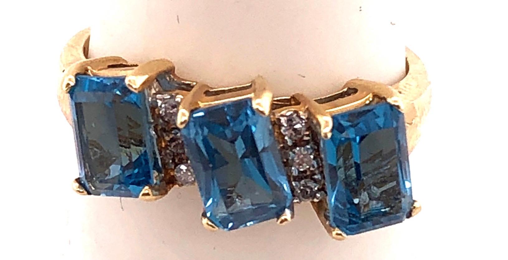 Modern 14 Karat Yellow Gold Ring Princess Cut Three Blue Topaz with Diamond Accents For Sale