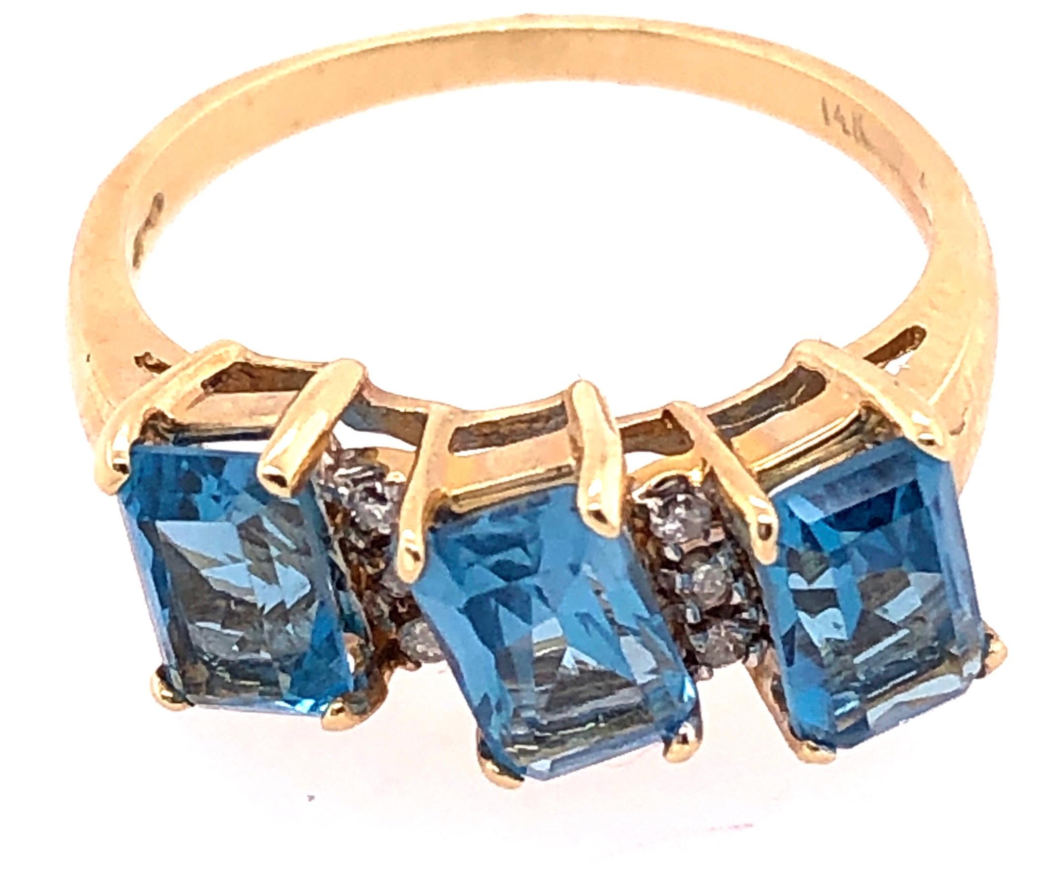 Cushion Cut 14 Karat Yellow Gold Ring Princess Cut Three Blue Topaz with Diamond Accents For Sale