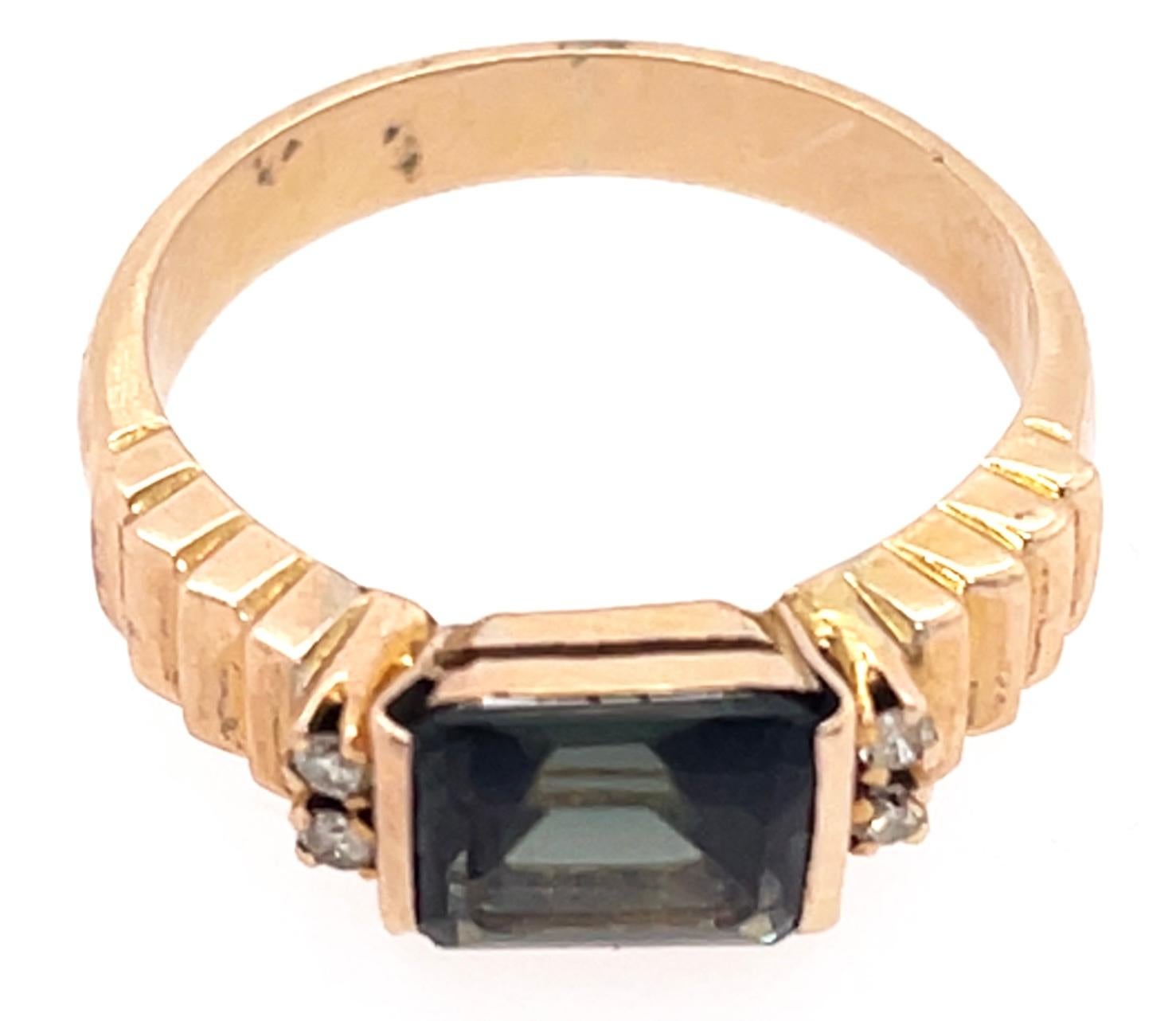 Contemporary 14 Karat Yellow Gold Ring with Center Emerald Cut Peridot and Diamonds