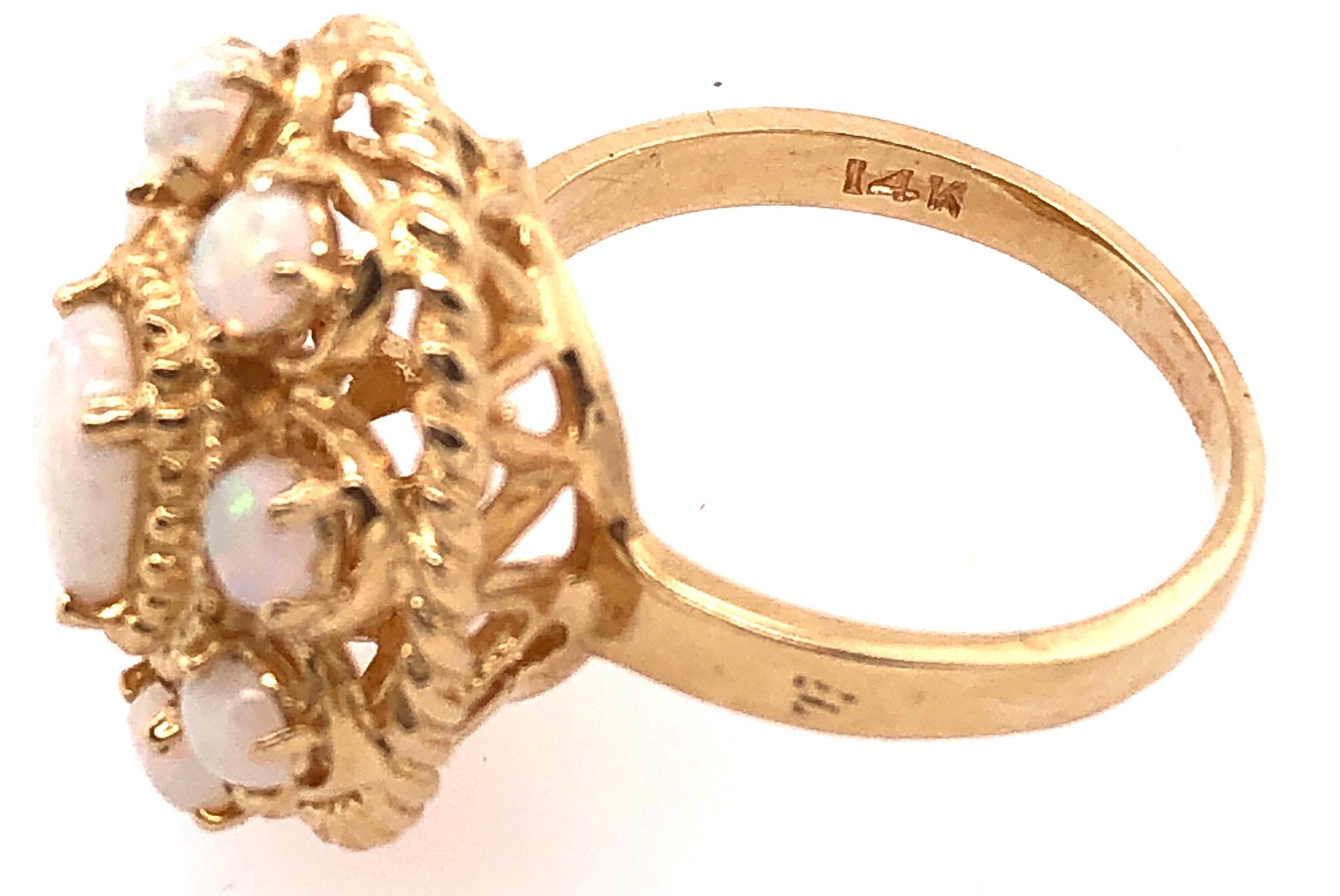14 Karat Yellow Gold Ring With Opal Cluster.
Size 8.75
8.9 grams total weight.