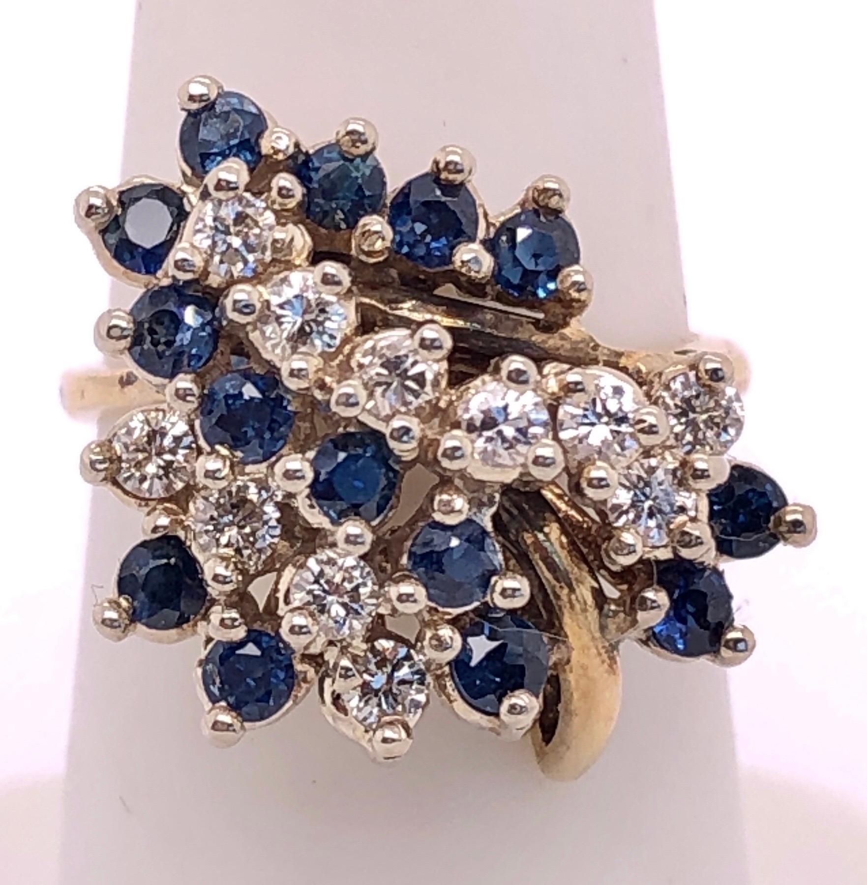 14 Karat Yellow Gold Ring with Sapphire and Diamond Cluster
0.80 total diamond weight.
14 piece round sapphire
Size 6
7 grams total weight.

