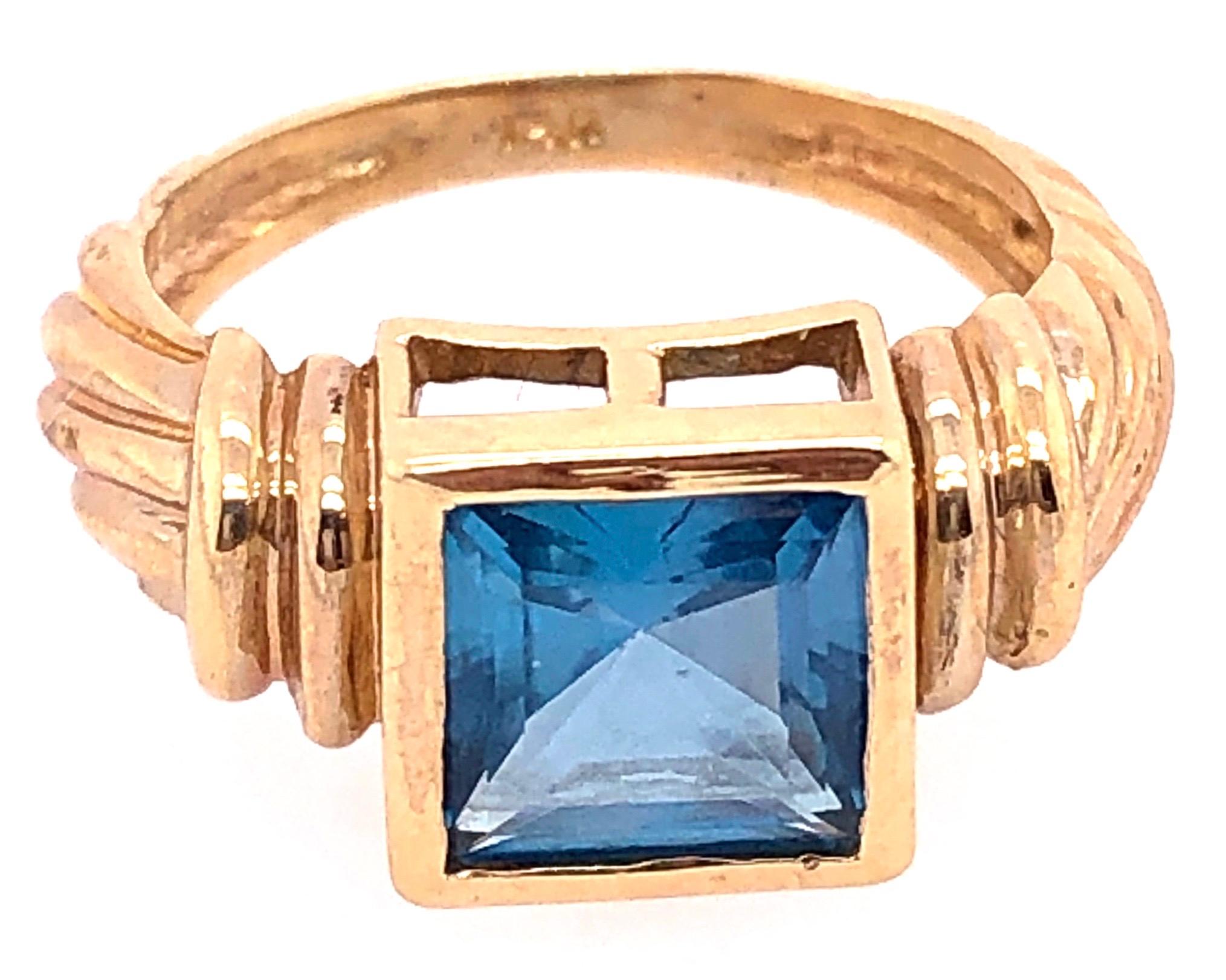 Contemporary 14 Karat Yellow Gold Ring with Solitaire Center Aquamarine Emerald Cut For Sale