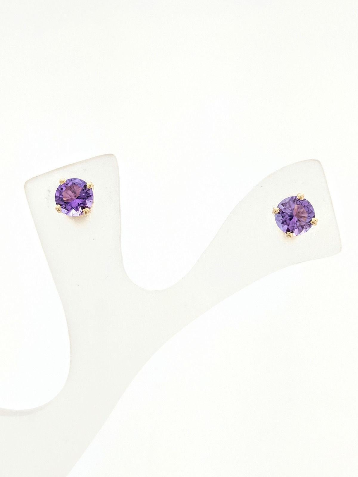 You are viewing a beautiful pair of amethyst stud earrings. These earrings are crafted from 14k yellow gold and weighs 1.1 grams. Each earring features (1) 5mm round amethyst gemstone set in a 4-prong basket setting with post backs. These earrings