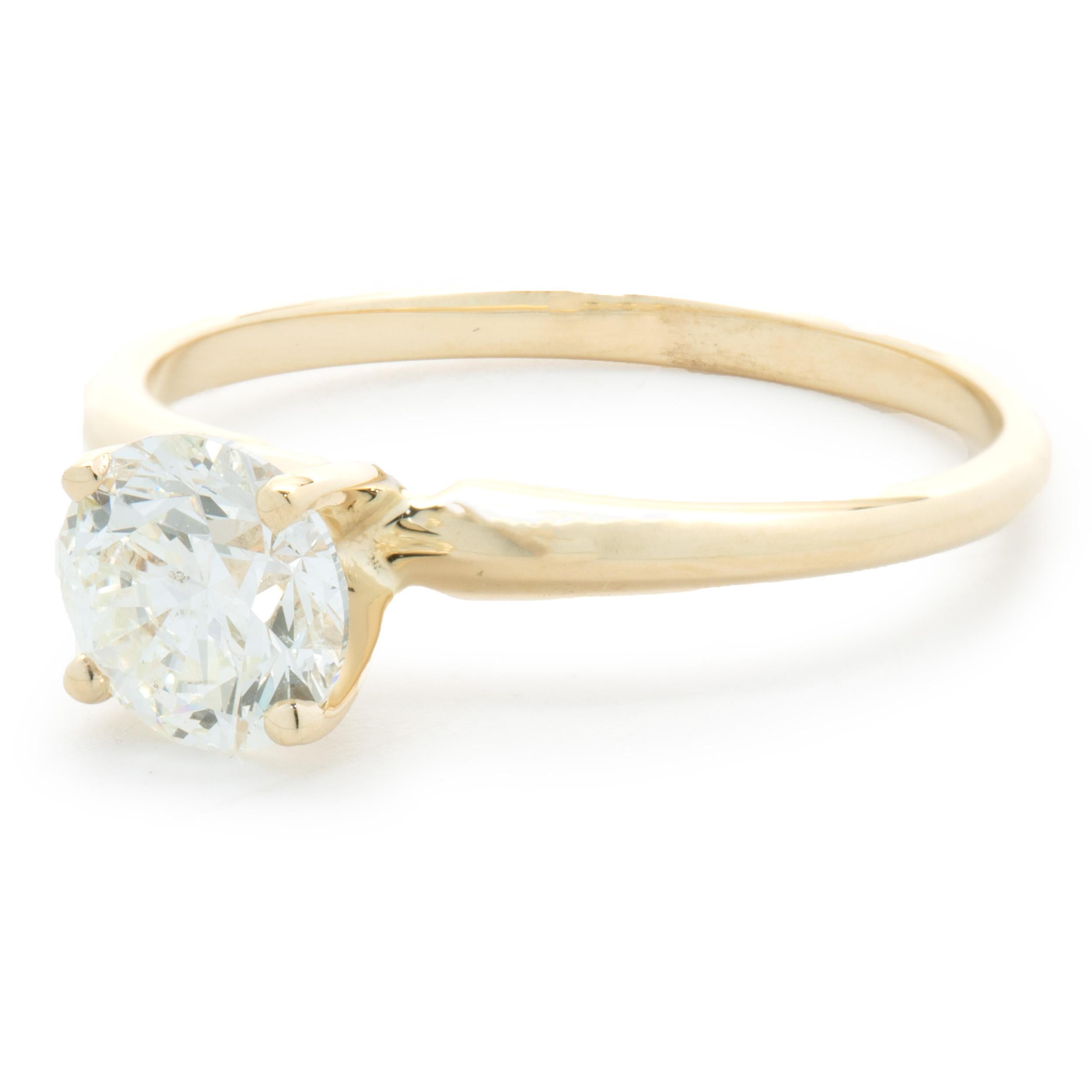 Designer: custom
Material: 14K yellow gold
Diamond:  1 round brilliant cut = 1.01ct
Color: J
Clarity: I1
GIA: 1379709771
Dimensions: ring top measures 6.5mm wide
Ring Size: 7 (complimentary sizing available)
Weight: 1.89 grams