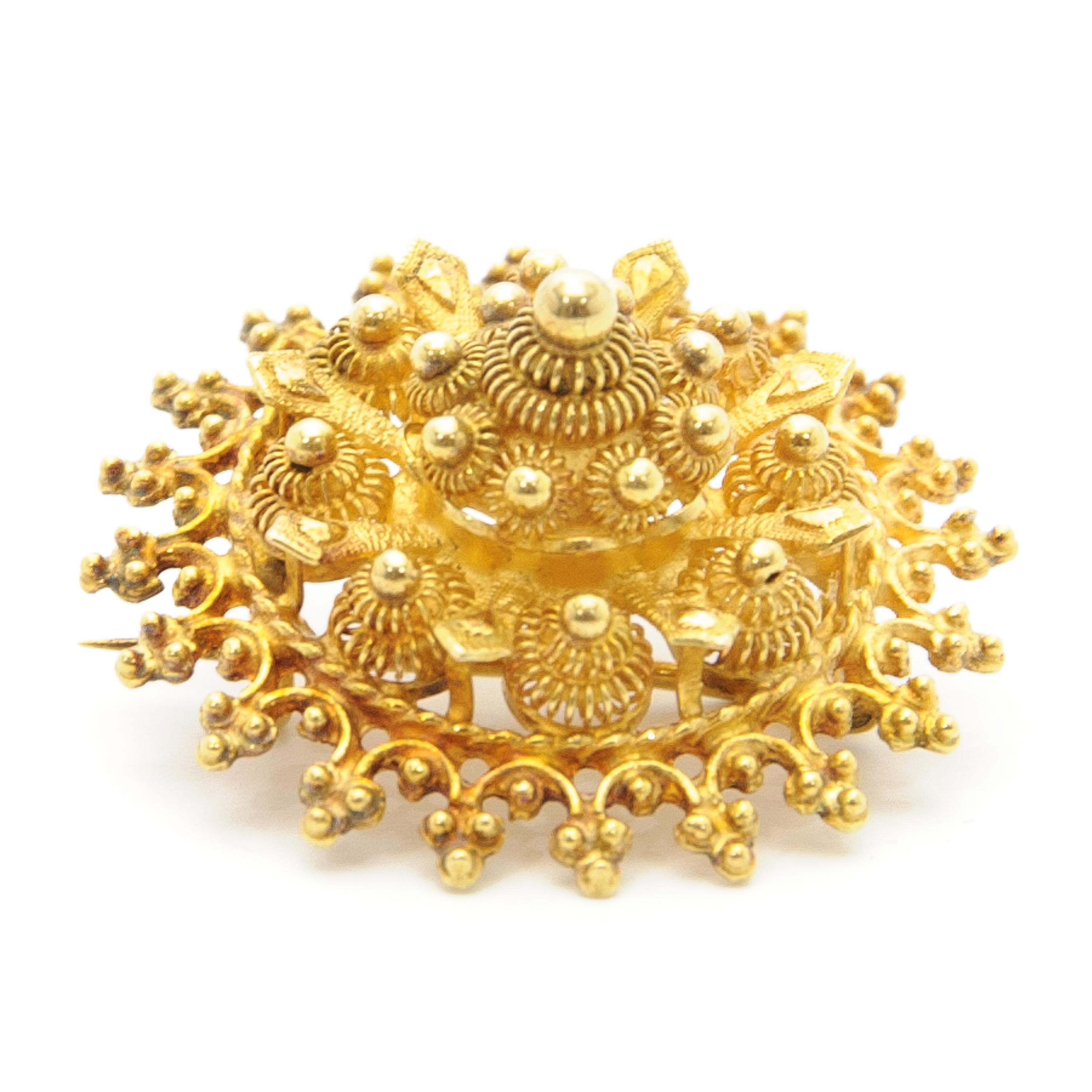 Etruscan Revival 14 karat yellow gold pin brooch made of cannetille and granulation work. The brooch is delicately handcrafted with fine gold wirework, small gold balls on top of the brooch. 

These kinds of jewels represent a varied and rich