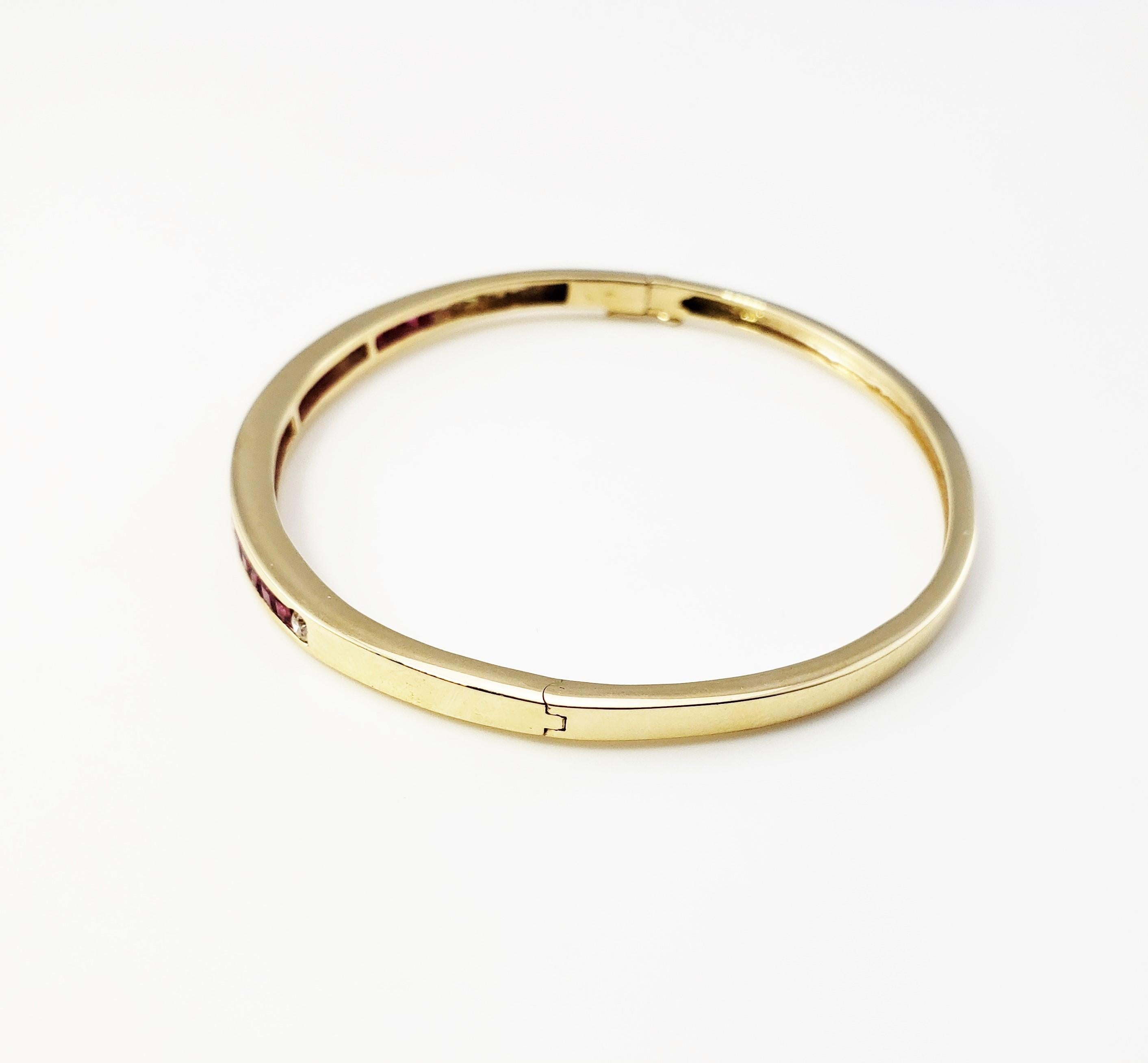Vintage 14 Karat Yellow Gold Ruby and Diamond Bangle Bracelet

This stunning hinged bangle bracelet features 20 princess cut rubies and five round brilliant cut diamonds set in elegant 14K yellow gold. Width: 4 mm. Safety closure.

Approximate total