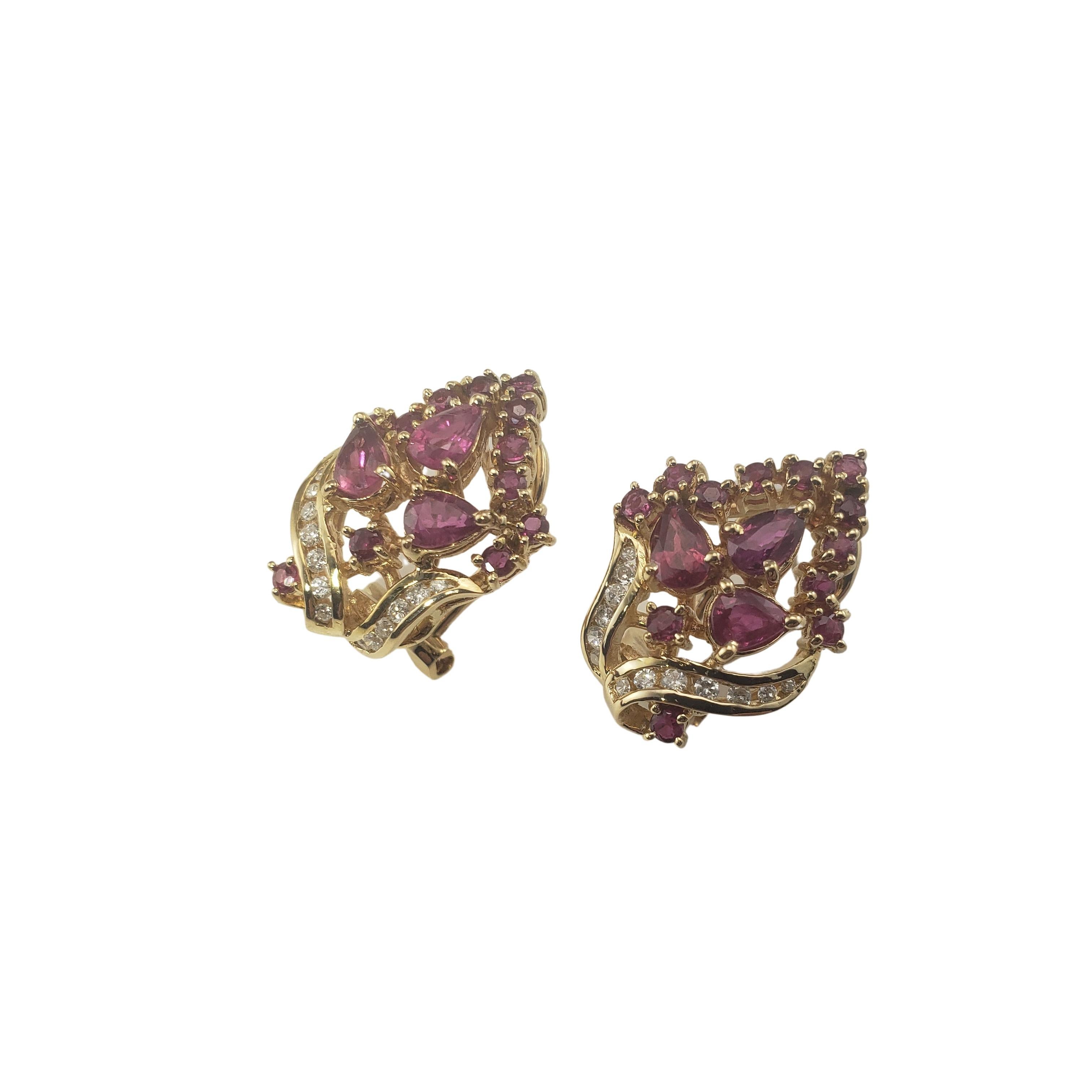 14 Karat Yellow Gold Natural Ruby and Diamond Earrings-

These lovely earrings each features 15 rubies and 13 round brilliant cut diamonds set in beautifully detailed 14K yellow gold.  Hinged closures.

Approximate total diamond weight:  .15