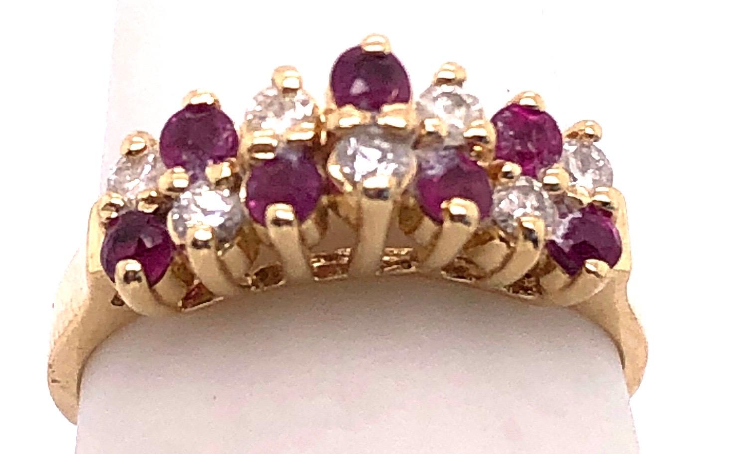 14 Karat Yellow Gold Ruby and Diamond Fashion Ring
Size 5.75
2.91 grams total weight.