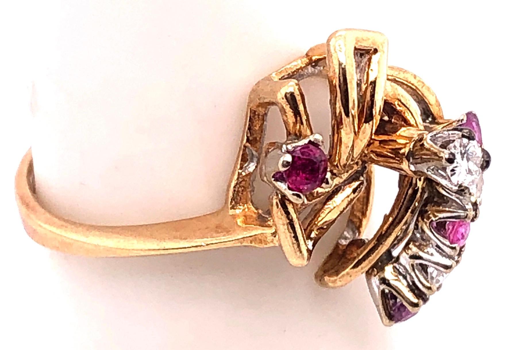 14 Karat Yellow Gold Contemporary Ring with Rubies and Diamonds.
0.03 total diamond weight.
Size 6.5
3.57 grams total weight.