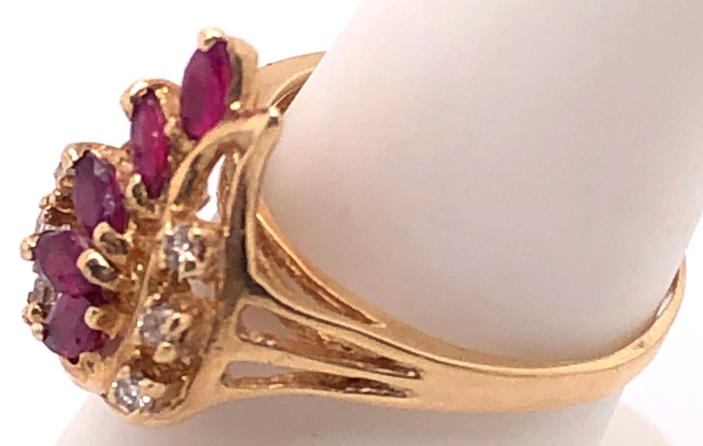 14 Karat Yellow Gold Ruby And Diamond Free Form Ring 
0.15 Total diamond weight.
Size 8
4 grams total weight.