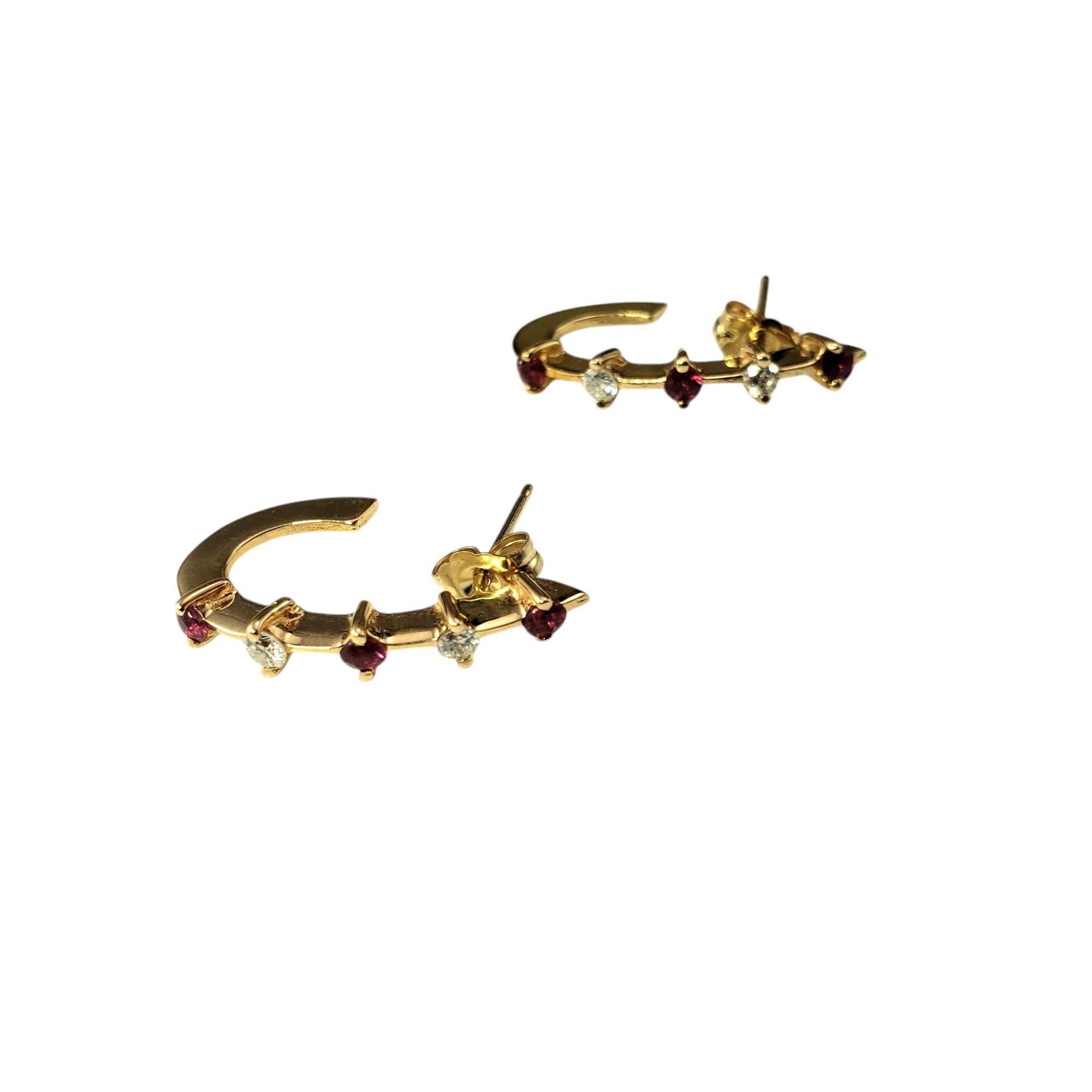 14 Karat Yellow Gold Ruby and Diamond Half Hoop Earrings-

These exquisite hoop earrings are each adorned with three round natural rubies and two round brilliant cut diamonds set in classic 14K yellow gold. Push back closures.

Approximate total