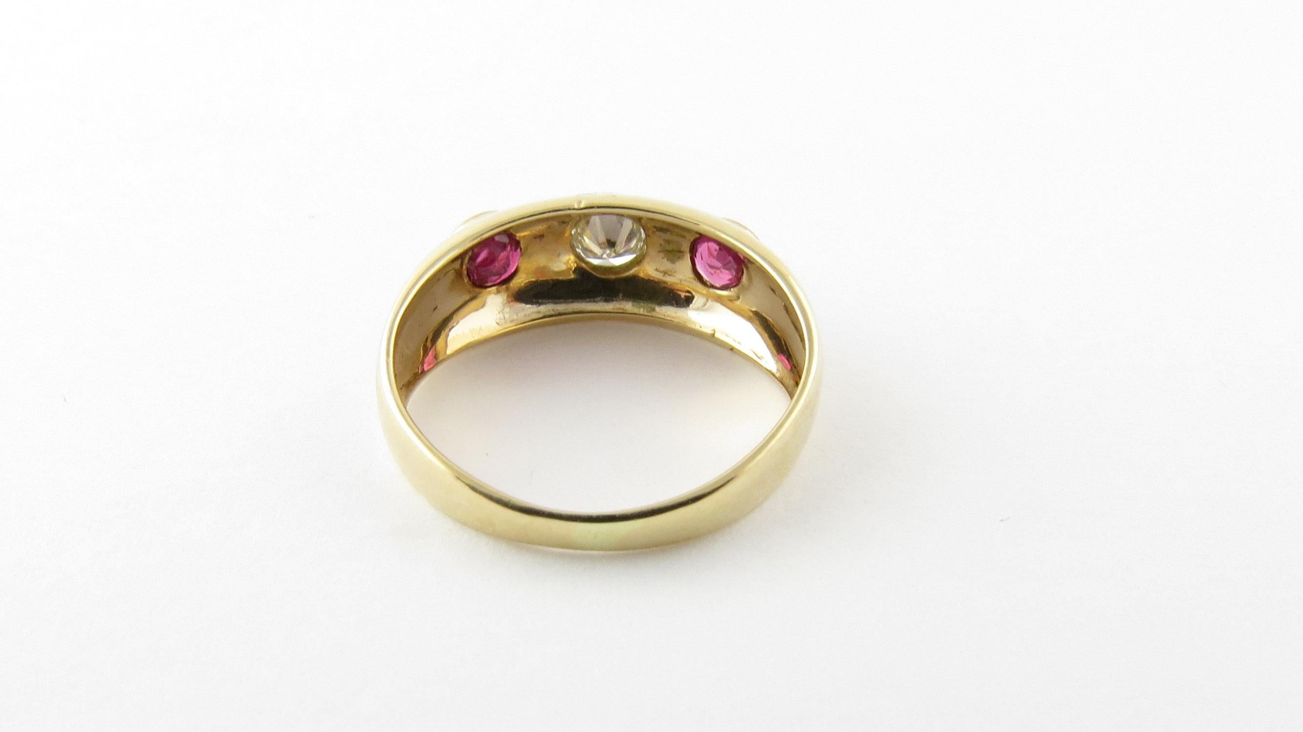 Vintage 14 Karat Yellow Gold Ruby and Diamond Ring Size 3- This lovely ring features two round rubies and one round brilliant cut diamond set in polished 14K yellow gold. Width: 6 mm. Shank: 2 mm. Approximate total diamond weight: .07 ct. Diamond