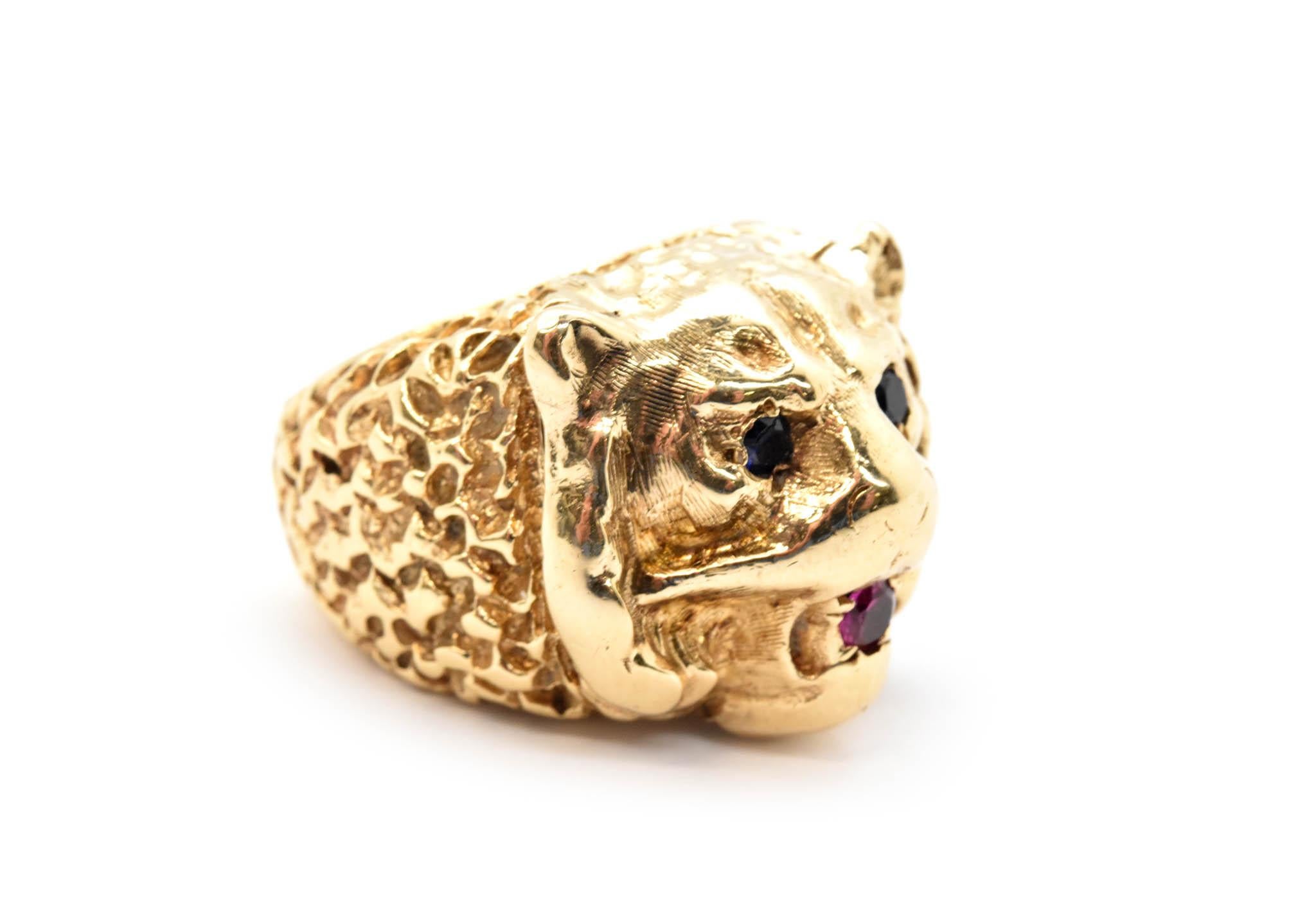 This ring is made in solid 14k yellow gold. The ring is in the shape of a bear head with sapphire eyes and a ruby in its mouth. The ring measures 19mm wide, and it weighs 31.53 grams. The ring is a size 5.