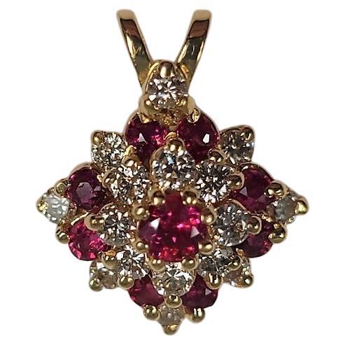 This lovely 14 karat yellow gold, 0.35 carat ruby and 0.50 carat diamond pendant is suspended from a 16 inch, yellow gold chain. 