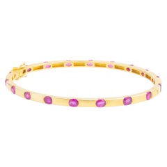Brazalete con bisagra de oro amarillo de 14 quilates y rubí