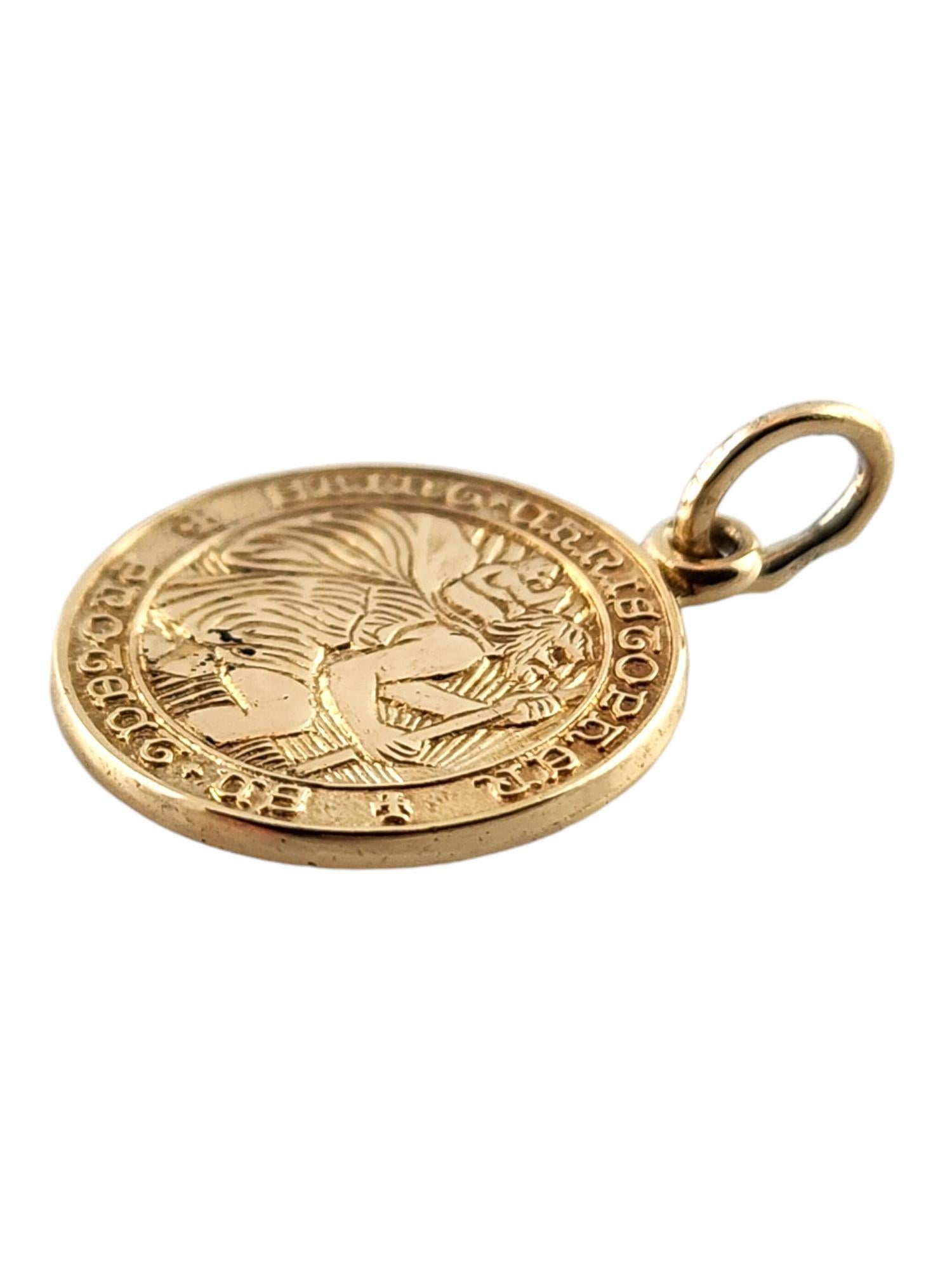 14 Karat Yellow Gold Saint Christopher Protect Us Charm

This beautiful 