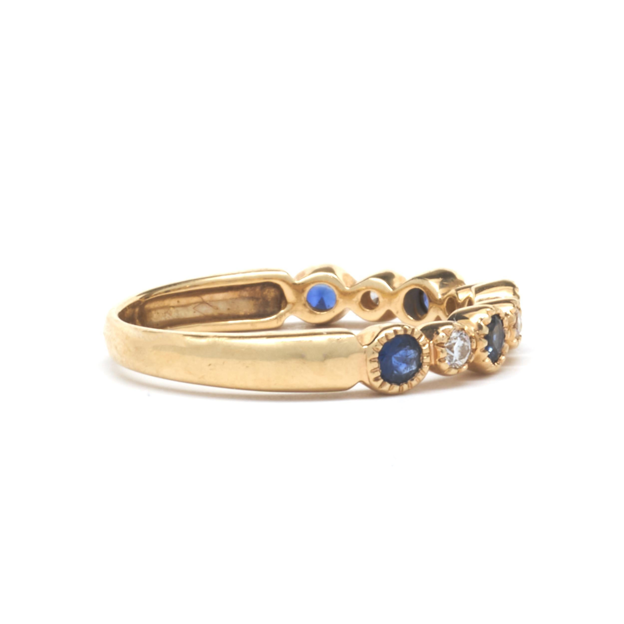 Designer: custom design
Material: 14K yellow gold
Diamond: 4 round brilliant cut = .11cttw
Color: G
Clarity: VS1
Sapphire: 5 round cut = .45cttw
Dimensions: ring top measures 3.21mm wide
Ring Size: 5.5 (please allow two extra shipping days for