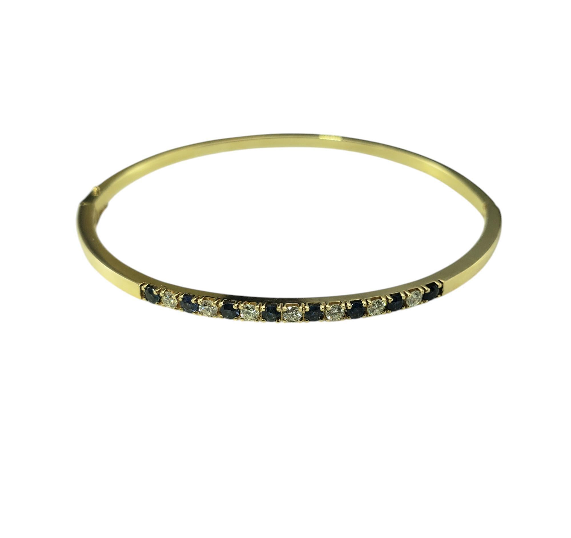 14K Yellow Gold Sapphire and Diamond Bangle Bracelet JAGi Certified-

This stunning hinged bangle bracelet features eight round cut natural blue sapphires and seven round brilliant cut diamonds set in 14K yellow gold. Width: 2.4 mm.

Approximate
