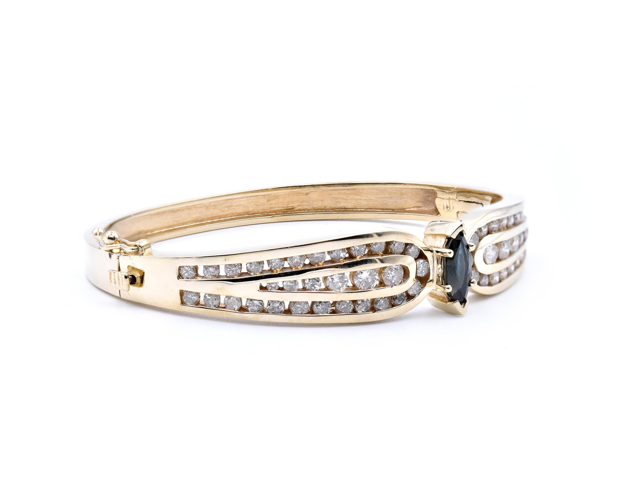 Material: 14K Yellow Gold 
Sapphire: 1 marquise cut = 1.02ct
Diamonds: 38 round cut = 2.42cttw
Color: H
Clarity: SI2
Dimensions: bracelet will fit a 6.5-inch wrist, measures 12.3mm in width
Weight: 28.7 grams