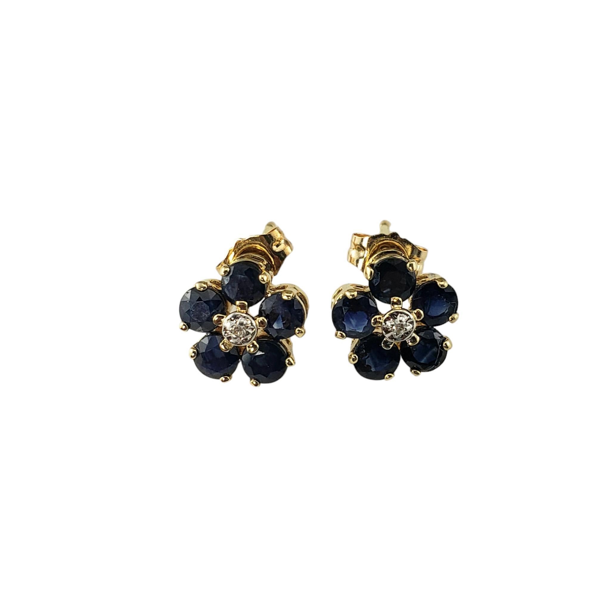 14 Karat Yellow Gold Sapphire and Diamond Flower Earrings JAGi Certified-

These lovely earrings each feature five round natural blue sapphires and one round single cut diamond set in classic 14K yellow gold.  Push back closures.

Total sapphire