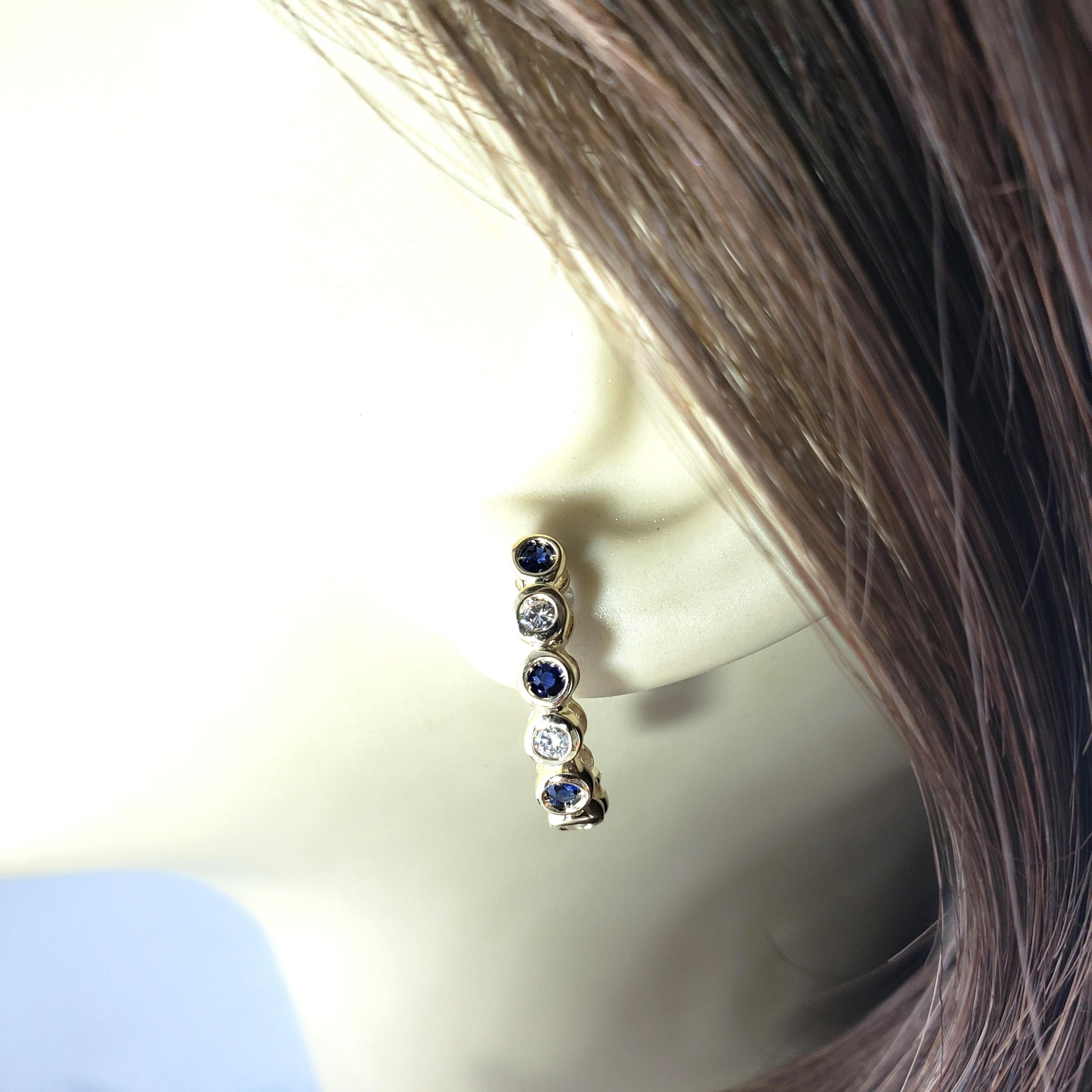 Vintage 14 Karat Yellow Gold Sapphire and Diamond Half Hoop Earrings-

These lovely earrings each feature three round brilliant cut diamonds and four round sapphires set in classic 14K yellow gold. Push back closures.

Approximate total diamond