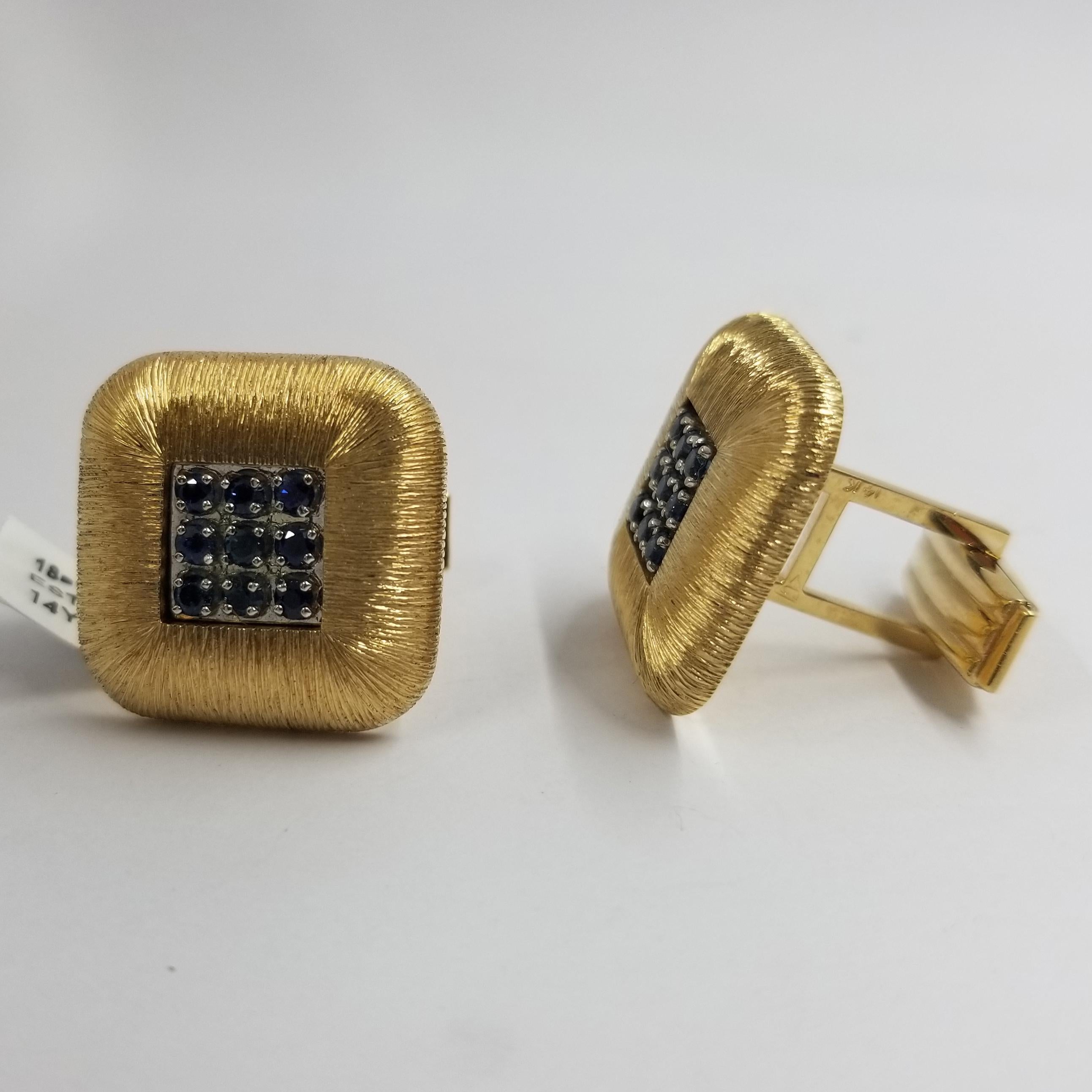 Set of 2 cufflinks crafted in 14 karat yellow gold (stamped). The front is textured in a radiating pattern around prong-set blue sapphires. 18 round sapphires total approximately 1.00 carat. The backs are a hinged torpedo style for easy dressing.