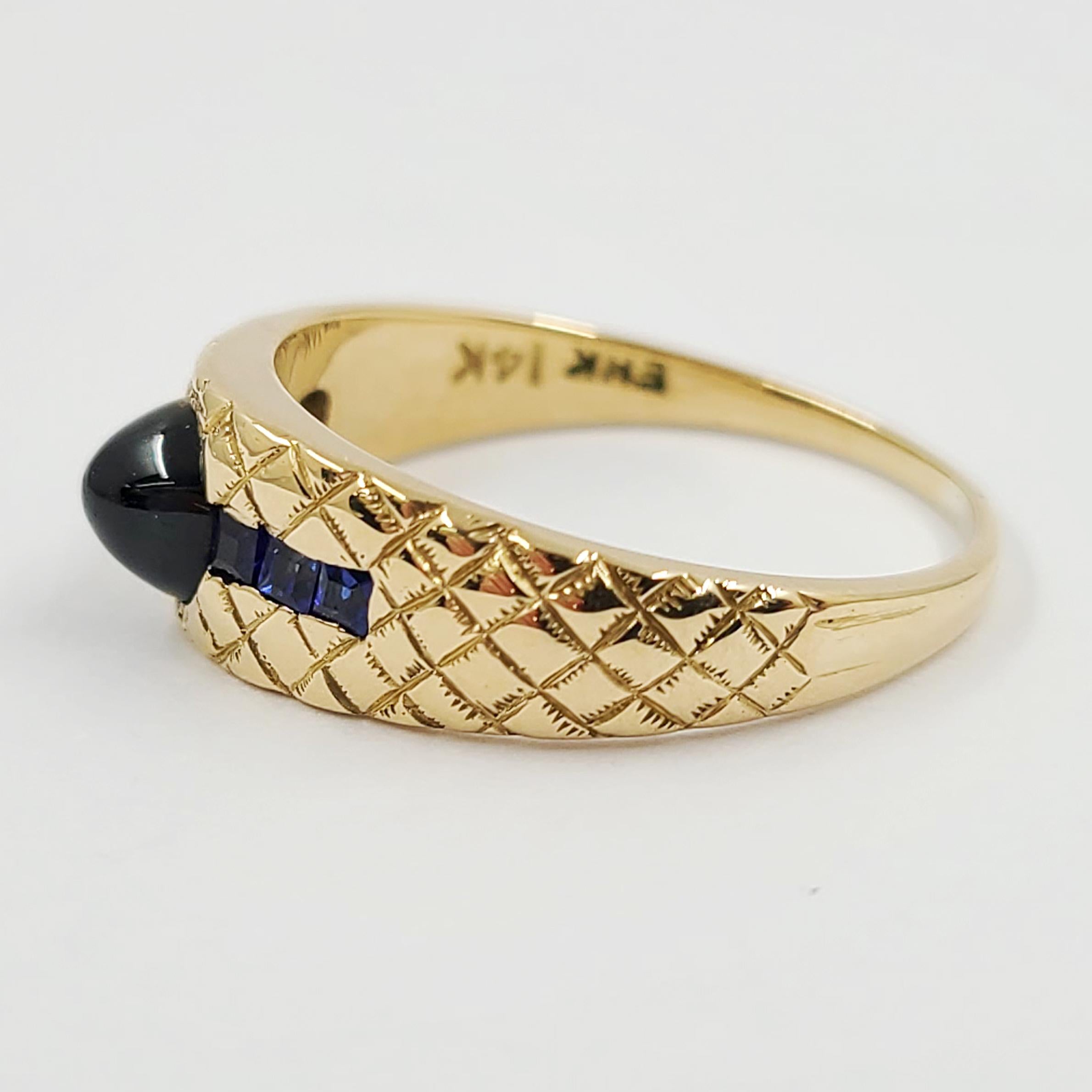 14 Karat Yellow Gold Ring Featuring A Sapphire Cabochon & 6 Square Cut Sapphires Totaling 0.50 Carats On A Quilted Texture Finish. Total Weight Is 4.2 Grams. Current Finger Size 9; Purchase Includes One Sizing.