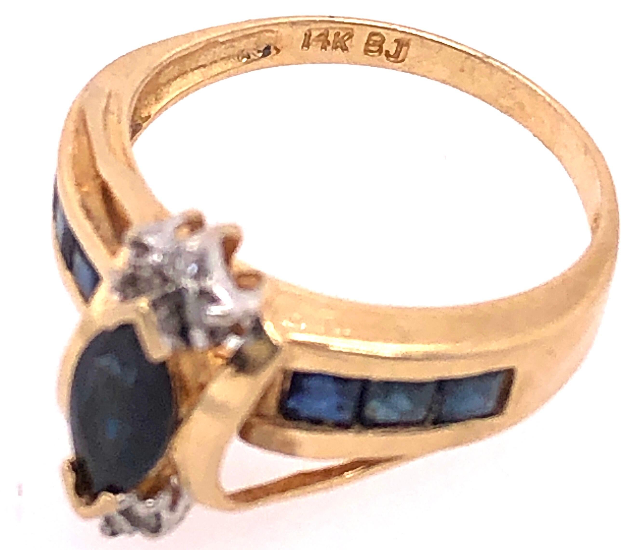 Modern 14 Karat Yellow Gold Sapphire Ring with Diamond Accents For Sale