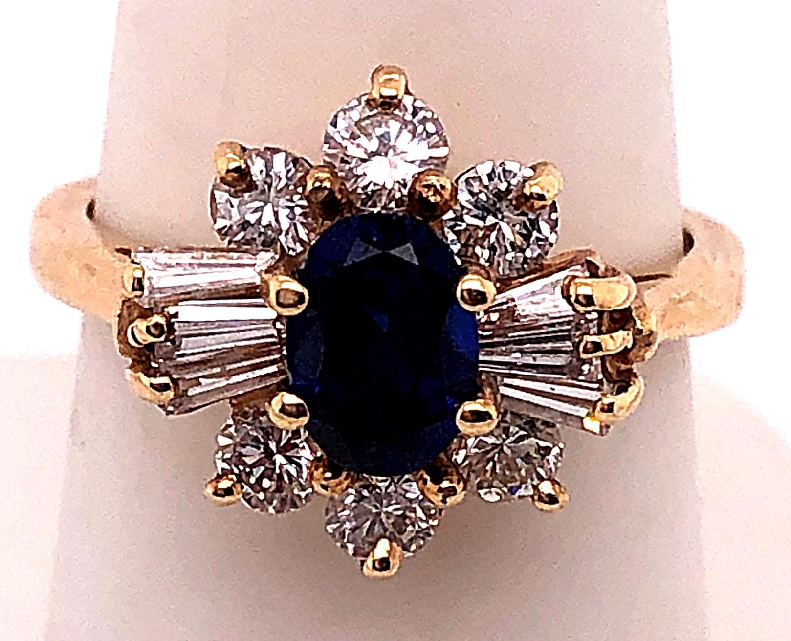 14 Karat Yellow Gold Fashion Ring with Blue Sapphire and Diamonds.
0.60 total weight of round diamonds
0.50 total weight of baguette diamonds
5.00 ct Blue Sapphire.
Size 7.5
5.20 grams total weight.
flower size: height 20 mm
                   width