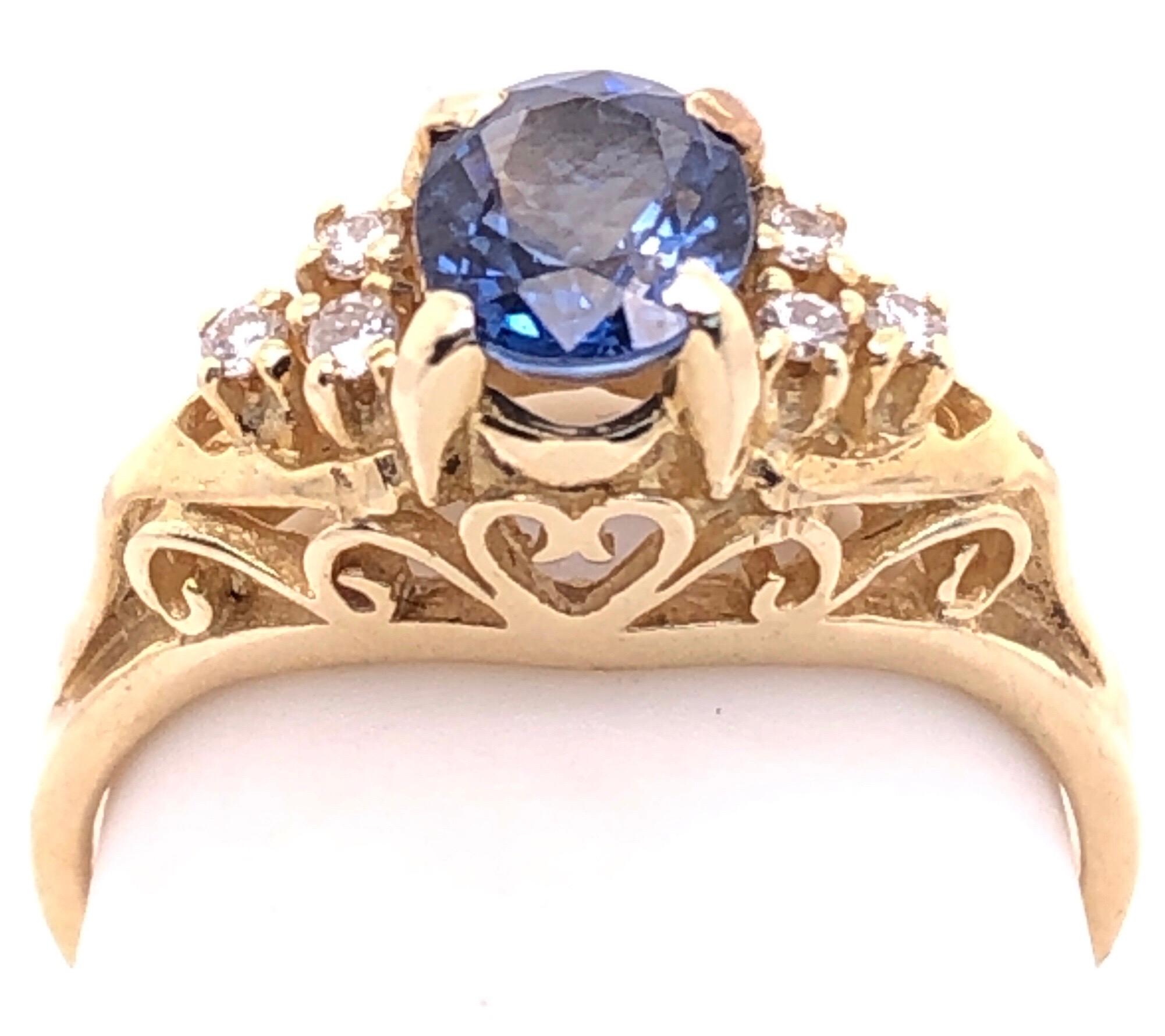 Brilliant Cut 14 Karat Yellow Gold Sapphire Solitaire Ring with Side Diamond Accents For Sale
