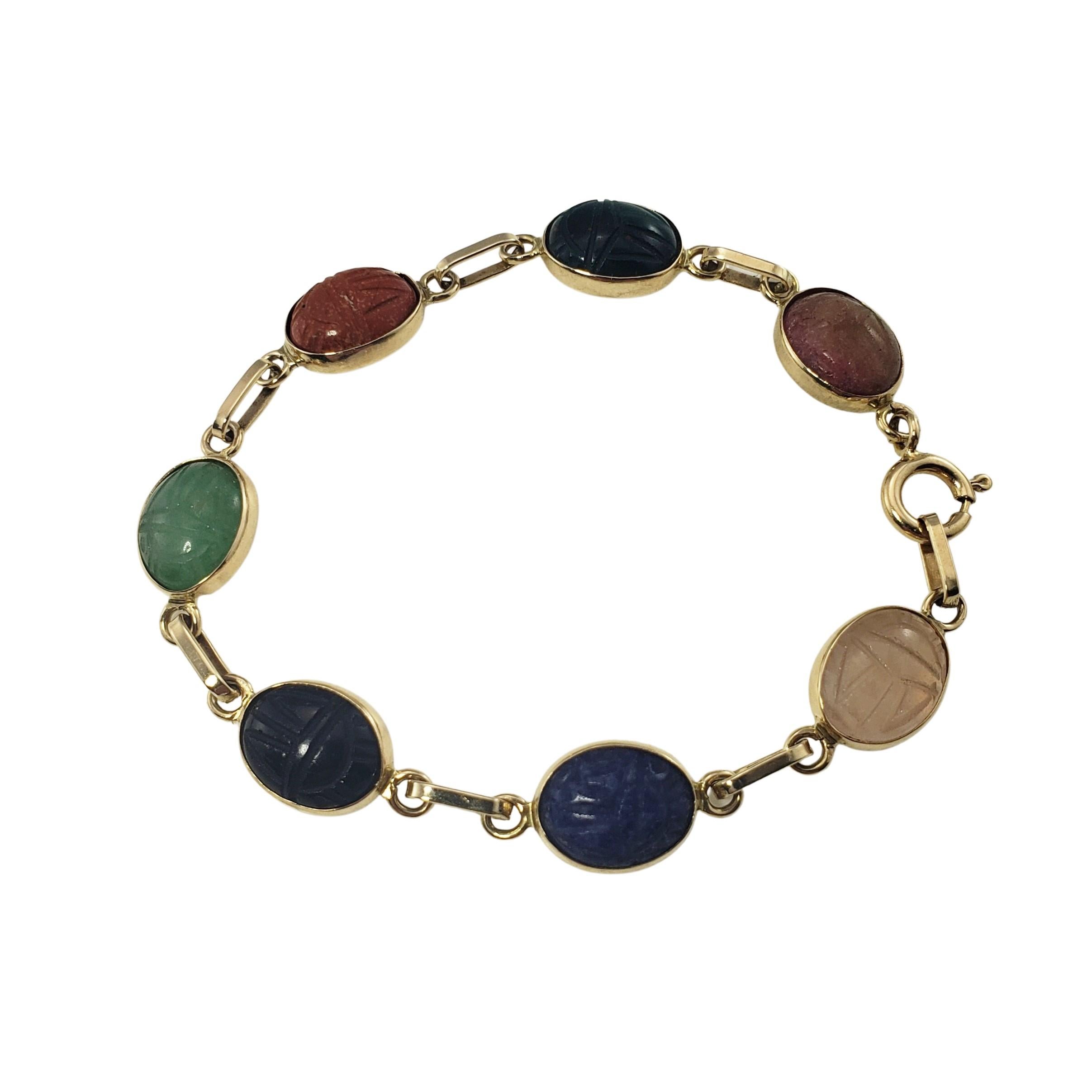 14 Karat Yellow Gold Scarab Bead Bracelet-

This lovely scarab bead bracelet features jade, carnelian, rose quartz, tiger's eye, lapis lazuli and onyx gemstones set in 14K yellow gold.  Each stone measures 11 mm x 8 mm.  

Size:  6.25