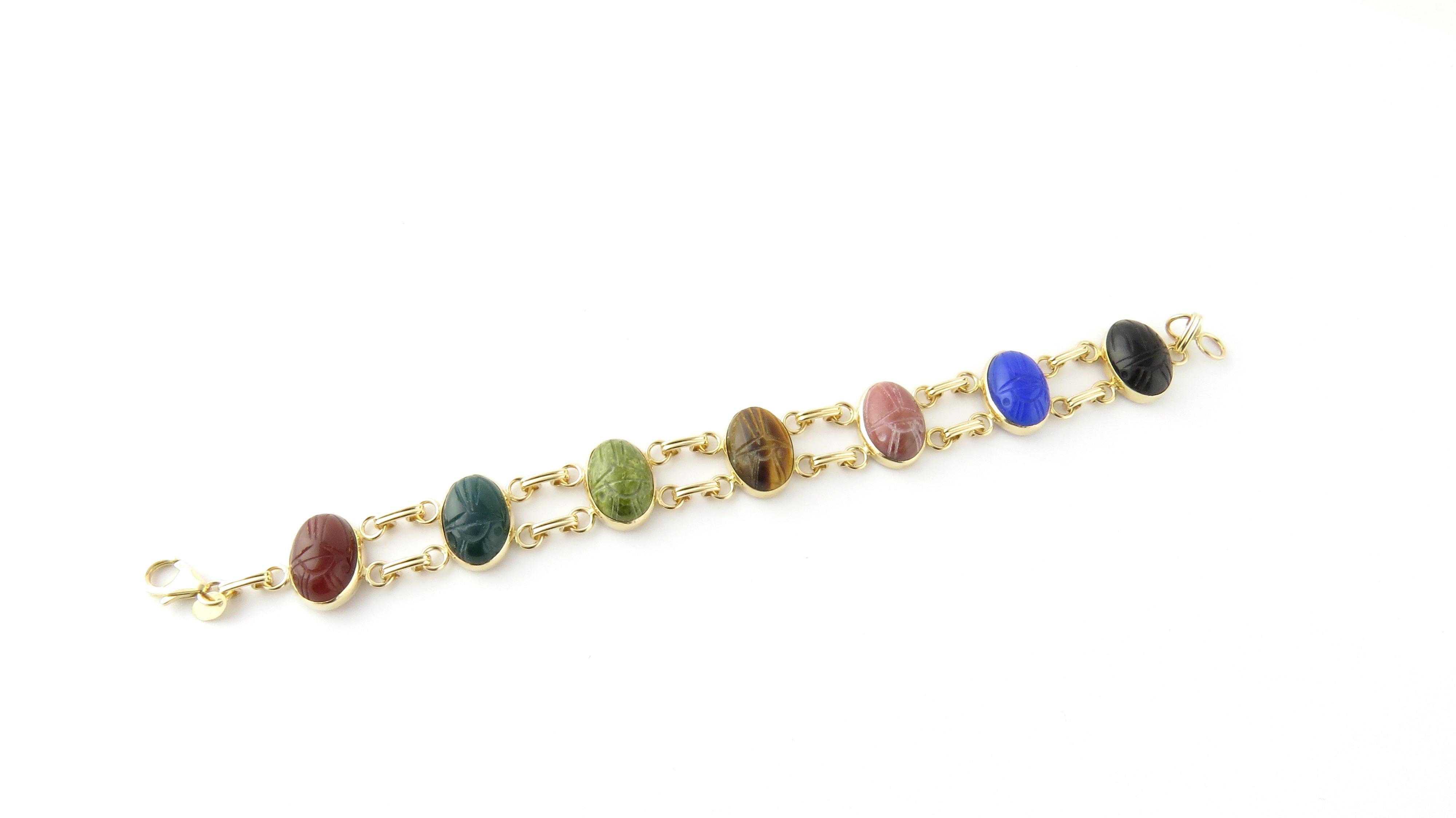 Vintage 14 Karat Yellow Gold Scarab Bracelet

This lovely scarab bracelet features seven oval semi-precious gemstones (14 mm x 11 mm); onyx, carnelian, tiger's eye, dark and light green marble, blue agate and quartz, set in classic 14K yellow